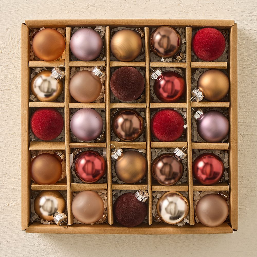 A box of small glass ornaments in copper, mauve, gold and deep red