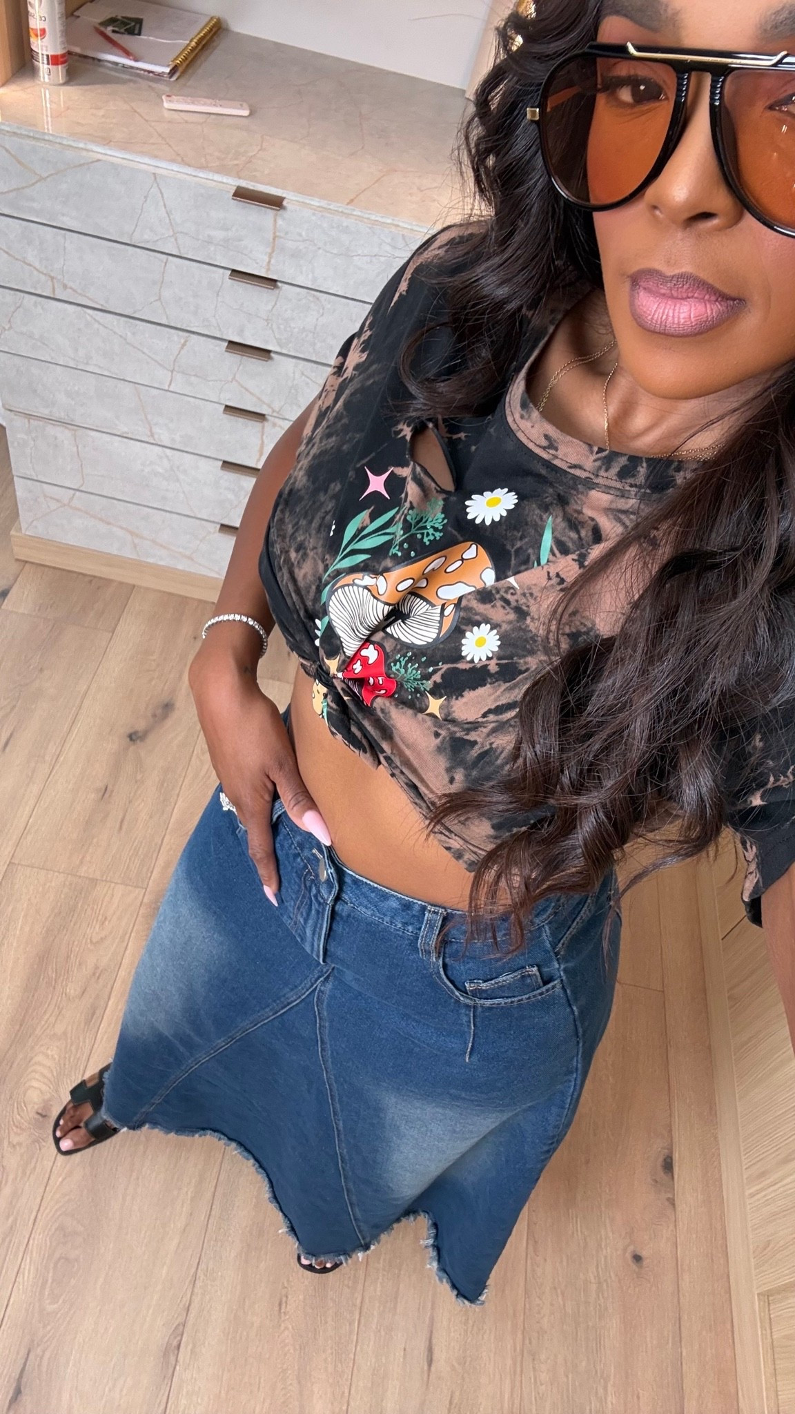 Hi Babes!

Okay this graphic tee and denim maxi skirt combo is giving cool-girl casual in the best way. I love mixing an edgy vintage-inspired tee with a feminine denim skirt because it creates that effortless outfit that looks styled without trying too hard.

If you're petite and curvy, this silhouette works so well because the high-waisted denim skirt defines the waist while the graphic tee keeps the look relaxed and comfortable. Add oversized sunnies and simple sandals and you're instantly put together.

Where to wear this:
• Weekend errands
• Casual brunch
• Farmers markets
• Concerts
• Travel days
• Coffee runs
• Everyday mom life

Undergarments: Seamless bra and seamless brief for the smoothest fit.

Everything is linked below.

xx Kira | IG: KirasFashionFinds

34D - 27 - 40 • Size Small or 4

Follow me on Instagram and YouTube @kirasfashionfinds