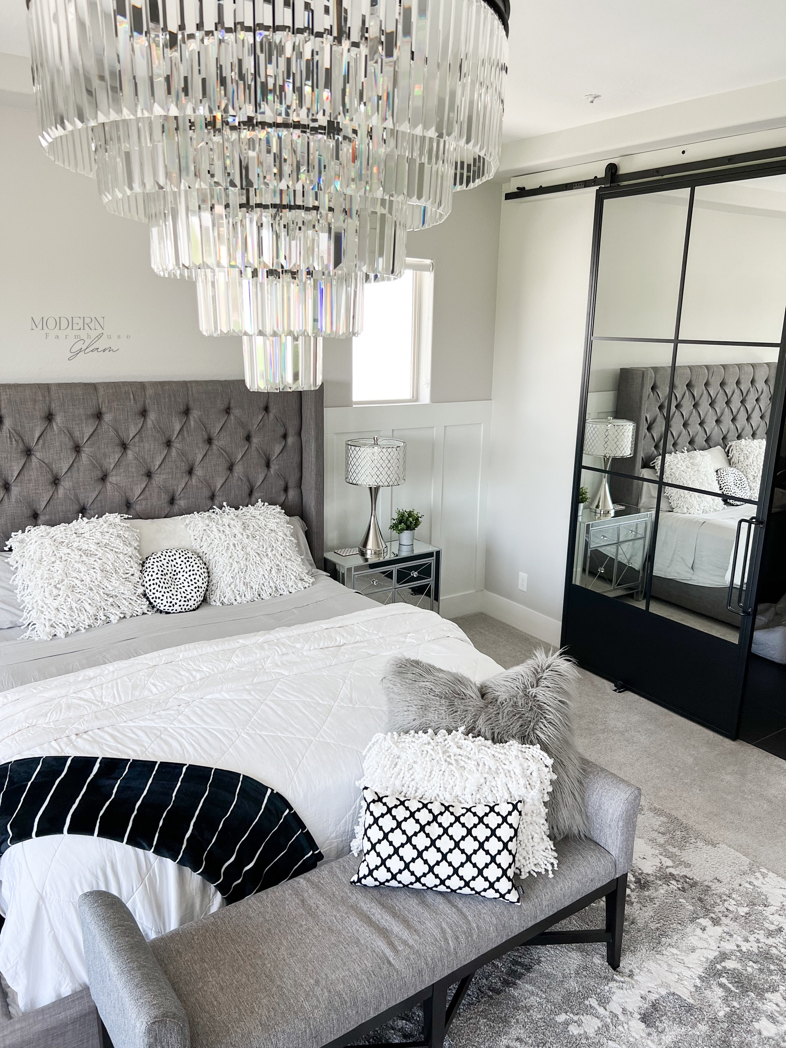 Master bedroom and chandelier at Modernfarmhouseglam 
Barn door, metal sliding door, bed tufted, headboard, neutral area rug, bedding nightstand lamp  

#LTKsalealert #LTKhome #LTKFind