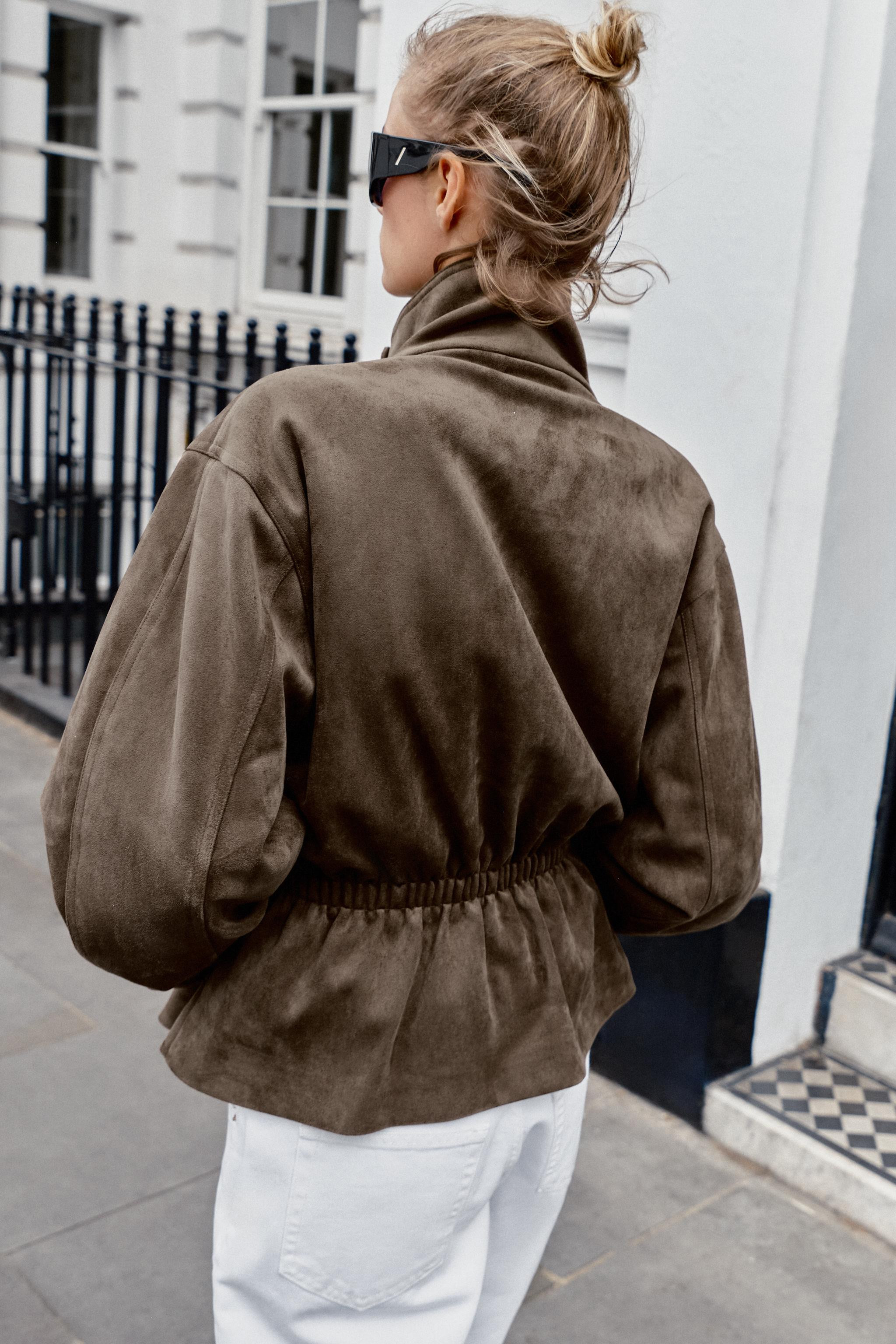 High-neck, long-sleeve jacket. Features front pockets, a matching fabric belt detail, and gathere... | Zara US