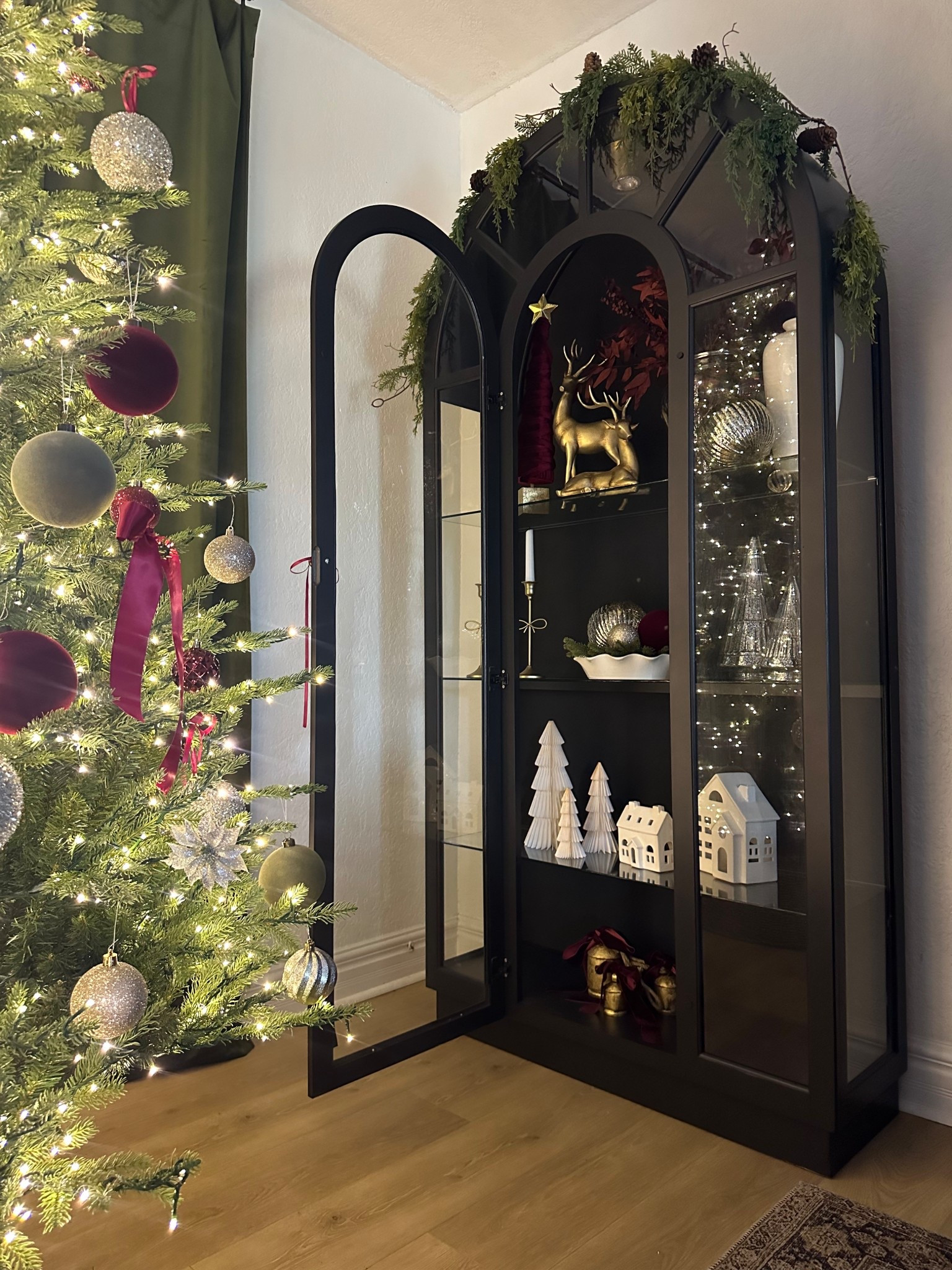 Vintage Arched cabinet styling for Christmas 
Walmart home decor
Pottery barn 
Vintage Christmas 
Ornaments 
Silver and gold 
Reindeer 
Ralph Lauren Christmas 
Pottery barn 
Walmart 
Designer look for less 
Glass cabinet 
Cozy home 
Christmas tree 
Style with me 
Walmart arched cabinet
Vintage decor 
Walmart home 
Vase 
Artwork 
Cabinet 
Dining room 
Credenza 
Moody 
French country #LTKStyleTip

#LTKFindsUnder50 #LTKHome #LTKSeasonal