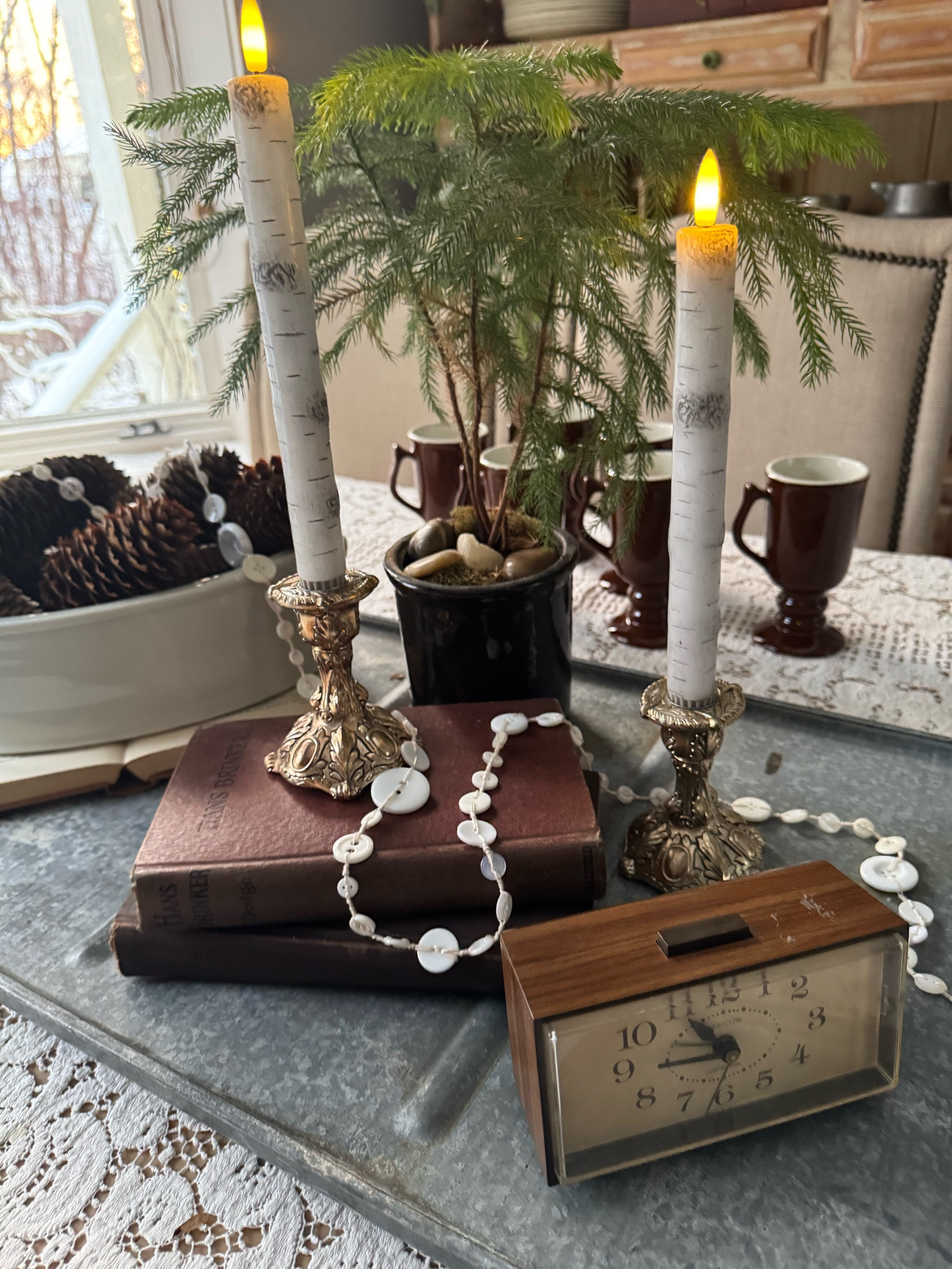 Love using this sweet white button garland in styling winter vignettes. With a couple old books, pinecones, and faux birch candles, a winter centerpiece comes together easily.

#LTKHome #LTKSeasonal #LTKStyleTip