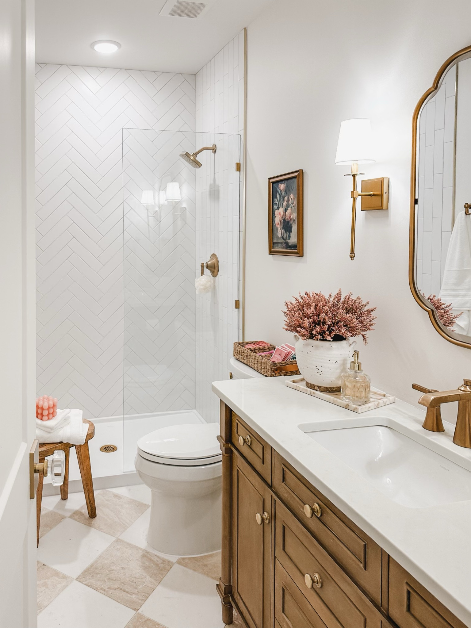Light and bright guest bathroom with warm whites, neutral wood tones, and pops of pink! The simplicity of this bathroom highlights the warm gold tones and the soft checkered tile. Love the glam vibe this space gives off.

Guest bathroom, bathroom refresh, warm whites, neutral wood tone, gold detail, pops of pink, light and bright, neutral aesthetic, furniture faves, faux florals, wall sconce, bathroom vanity, bathroom decor, style inspo, Wayfair, Michael’s, Target, spring refresh, shop the look!

#LTKhome #LTKstyletip 

#LTKSeasonal