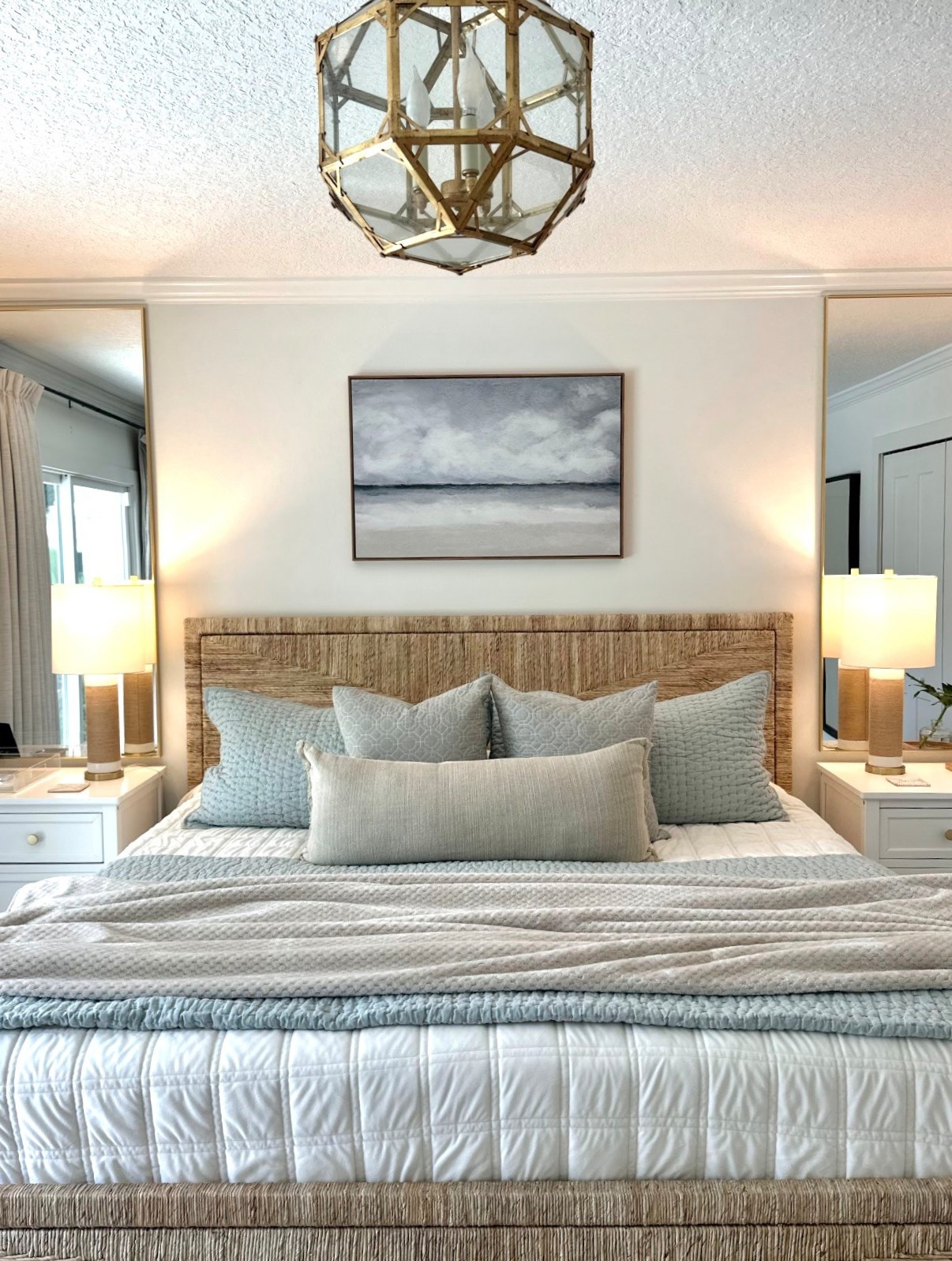 Primary bedroom bedding 
Woven bed frame 
Pillow covers 
Beach art 
Quilt sets 
Tall gold mirrors 

#LTKHome #LTKSeasonal #LTKSaleAlert