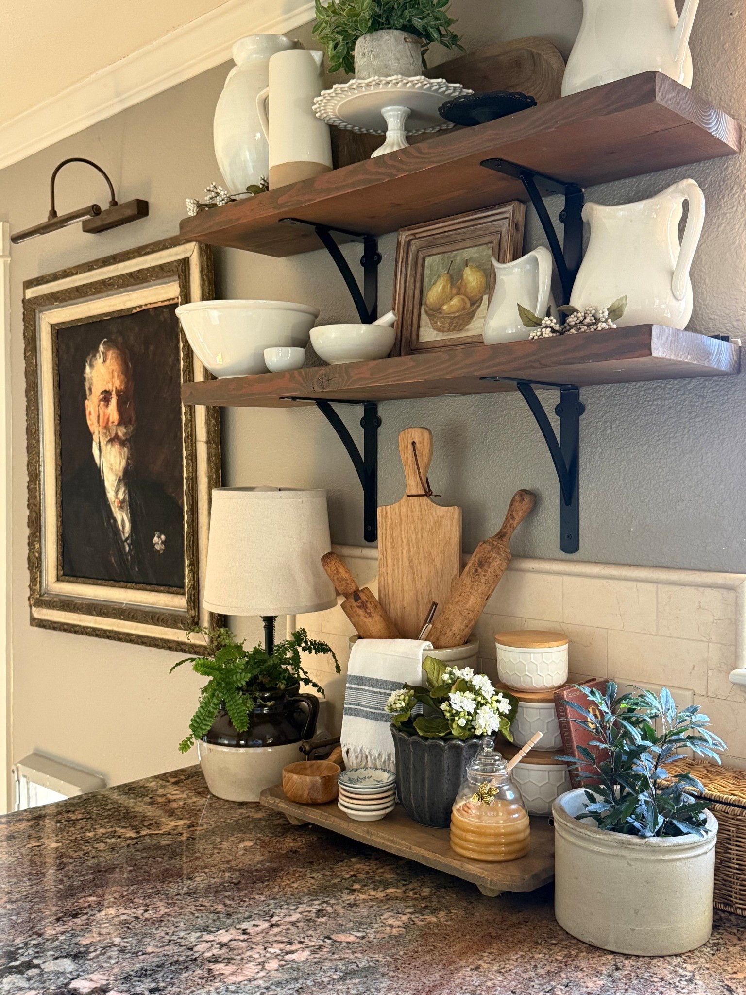 A European farmhouse kitchen vignette full of charm and collected beauty 🤍
Open shelving shows off ironstone dishes, cake stands, and ceramics, layered with story—antique crocks, rolling pins, a glass honey jar with a tiny bee, and an old bartender’s book. Soft greenery and plants add life and balance, making the space feel cozy, practical, and intentionally styled.


#LTKstorytime #LTKSeasonal #LTKHome
