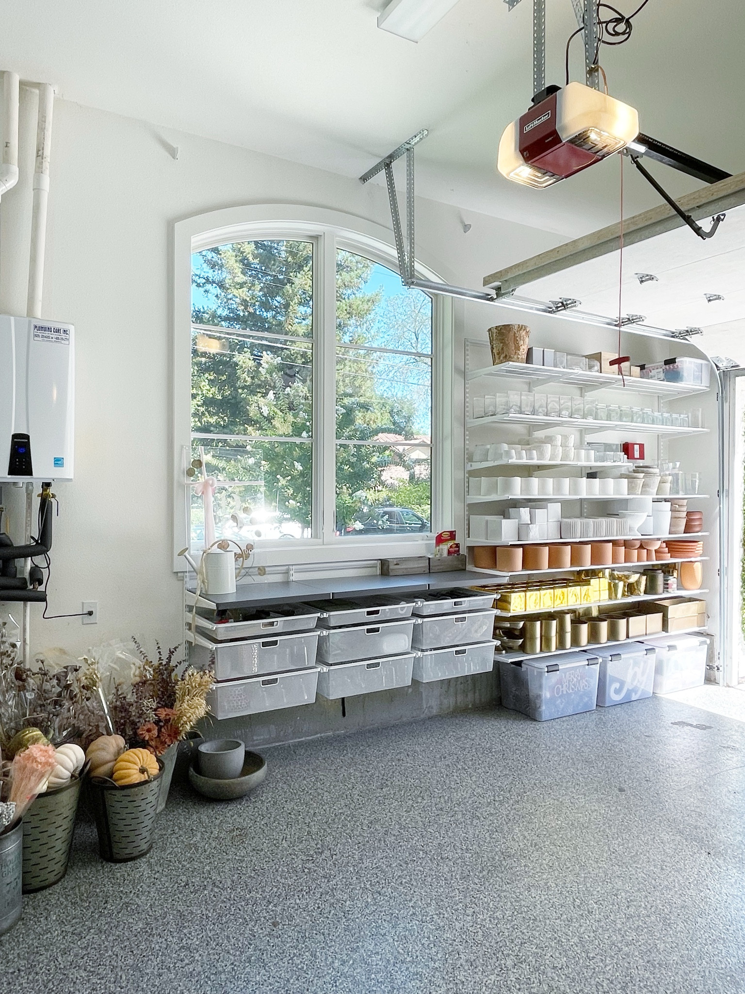 One of my favorite spaces to organize is a garage. The transformation in this space can be, and usually is completely epic! One of my favorite products to use in the garage to make the best use of vertical space is Elfafrom the Container Store. Right now their annual sale is on and it’s 30% off. This is an excellent time to purchase, the product to use anywhere in your home to create space that you can edit overtime. This is one of my favorite projects that I completed for a local florist who works out of her garage. I love how all the vases look on the shelf, and I love the drawers under the window.