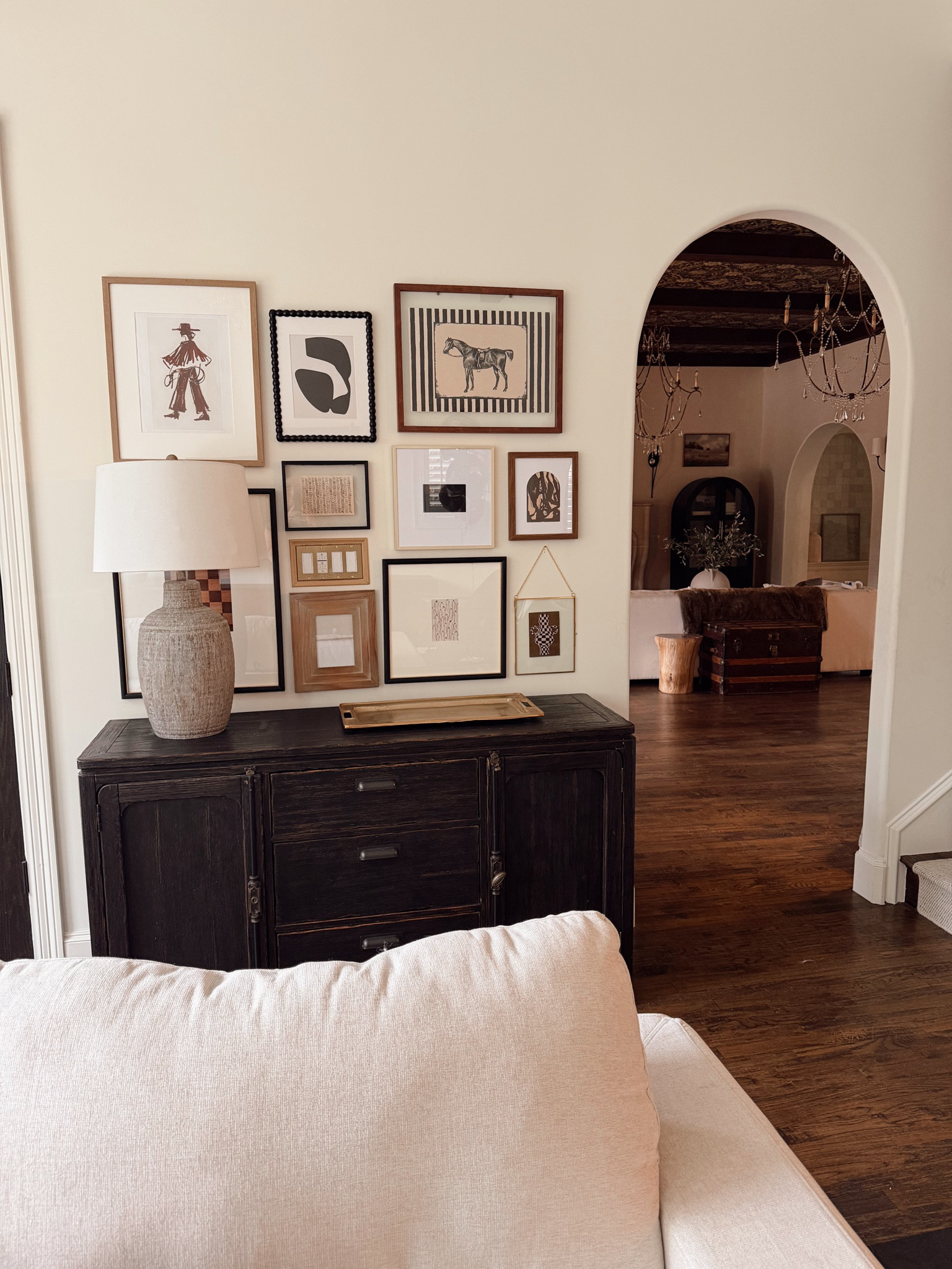 A little gallery wall moment that makes the whole room feel finished. Mixing wood tones, black frames, and neutral art keeps it collected but still cozy. This is one of my favorite ways to warm up a blank wall without overwhelming the space.

gallery wall inspiration, neutral home decor, traditional living room, wood console cabinet, black frame gallery wall, cozy home styling, classic interior design, warm wood floors, curated wall art, timeless home details

#LTKHome #LTKSeasonal #LTKdayinmylife
