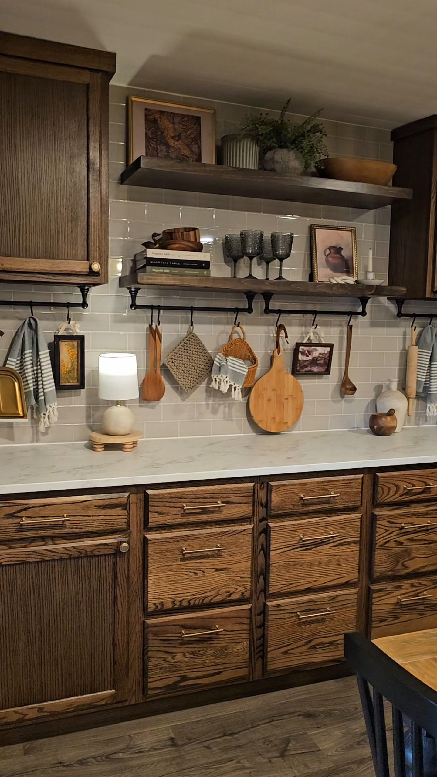 This full wall of built-in cabinets provides so much storage and character in our dining room. We used stock cabinets stained dark with a laminate faux marble countertop, gray tile backsplash, and floating shelves.  

 #LTKHome