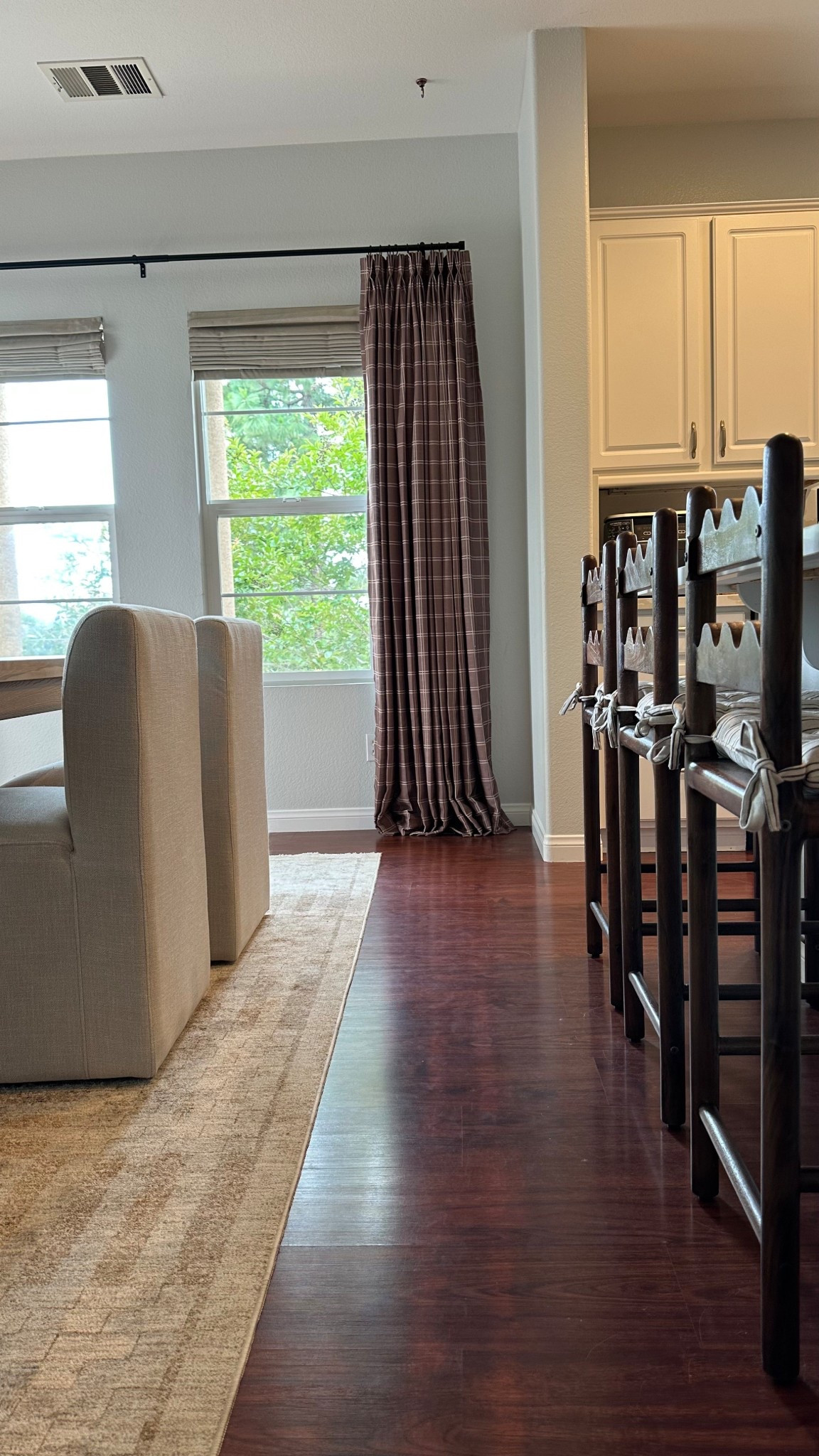 Brown patterned curtains, warm dining room, plaid brown curtains, fabric dining chairs, affordable, brown wavy barstools

#LTKHome