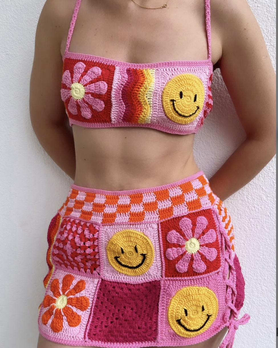 Bright, bold, and bursting with personality – this handmade crochet set by MARCELLINE features a daisy-embroidered crop top with a secret pocket and a matching mini skirt 🌈🌼 Made with vibrant patchwork and playful emoji-inspired stitching, it’s the perfect festival, rave, or streetwear statement piece. Ethically handmade, one-of-a-kind, and made to stand out in every crowd.