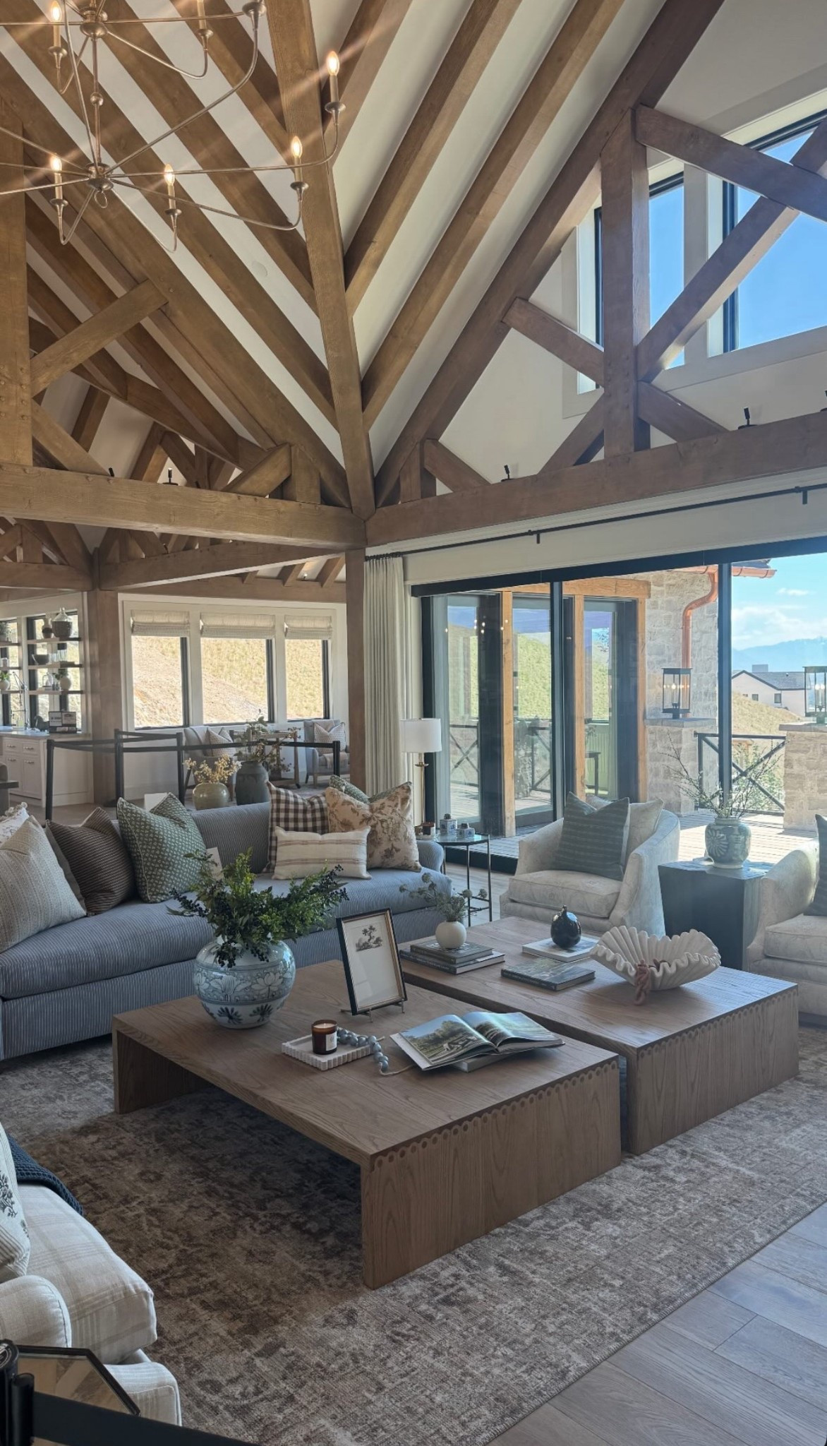 Escape to rustic elegance in this stunning great room with soaring vaulted ceilings, exposed timber beams, and floor-to-ceiling windows that flood the space with natural light. Cozy textures, layered neutral tones, and thoughtfully styled accents create a warm, inviting atmosphere—perfect for gathering with family or curling up with a book. Pin this mountain-modern living room for all the cabin-meets-luxury inspiration you need! 🏔🤍 #RusticModern #VaultedCeilings #MountainHome #InteriorInspo #CozyLivingRoom #OpenConceptDesign

#LTKHome