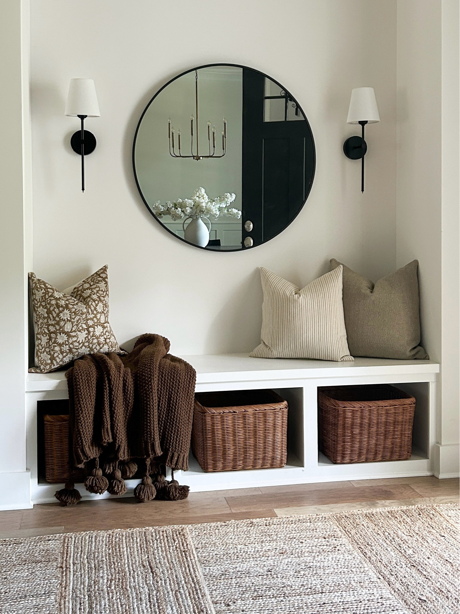 Our cozy inviting entryway with woven elements and jute texture, elevated with a mirror and accent lighting 🤍

#LTKMostLoved #LTKHome #LTKSeasonal