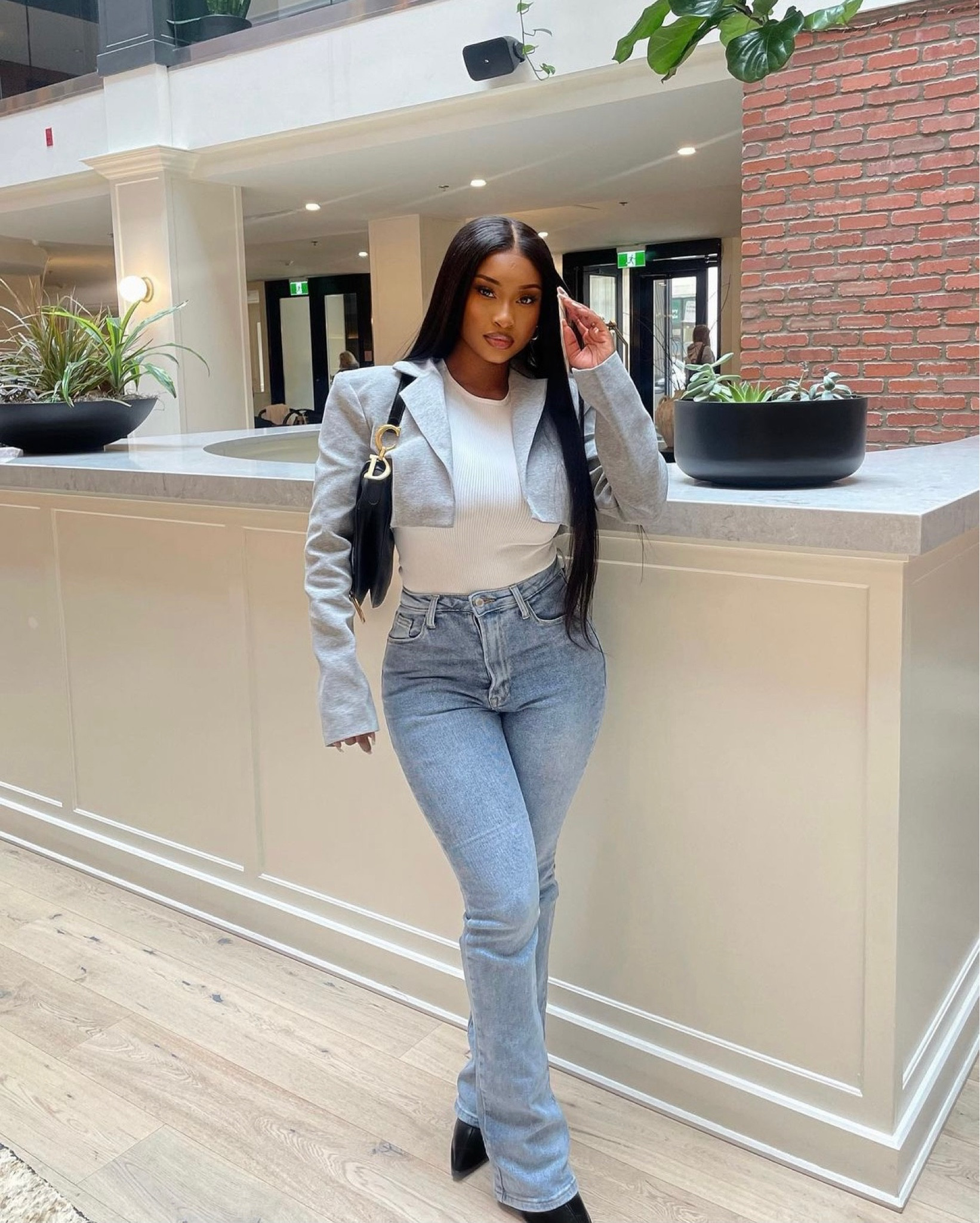 Casual and chic! We love a flared light blue jean, white top and grey cropped blazer

