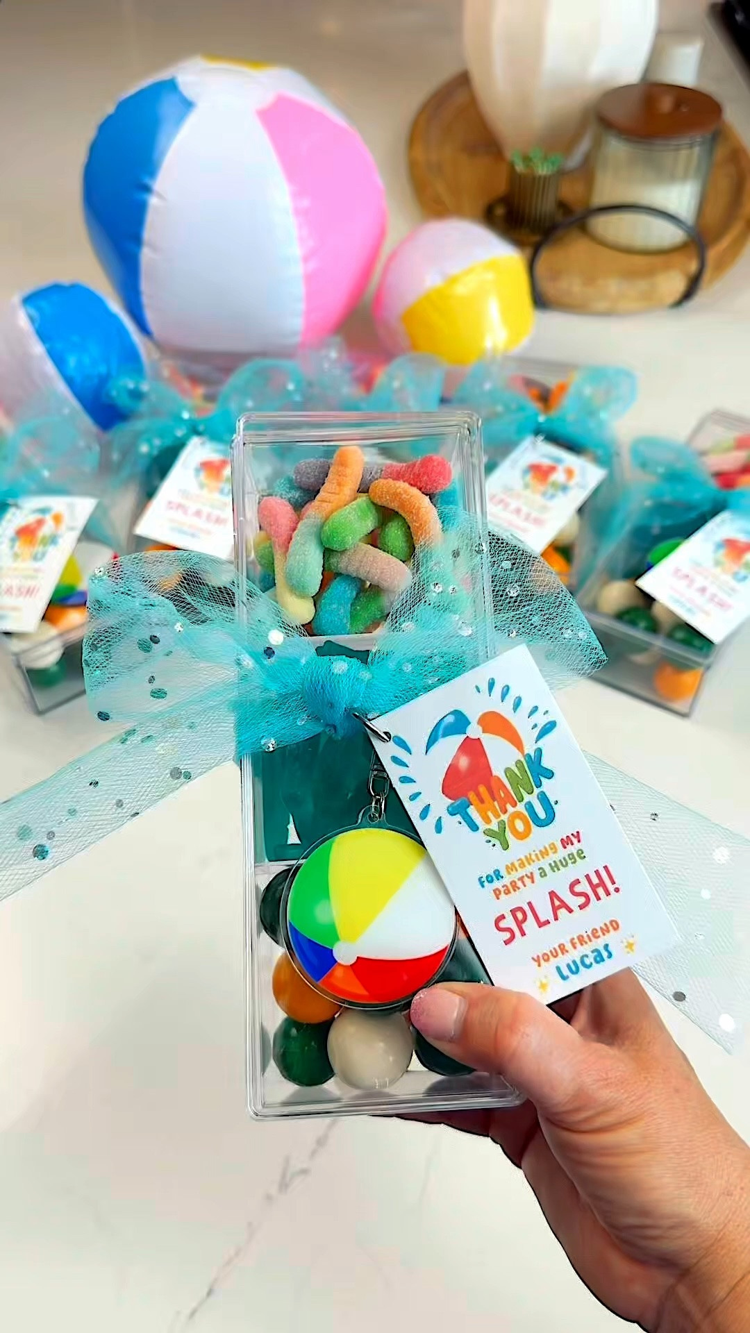 Copy this easy summer party favor idea before your next pool party 💦

I grabbed most of the items from Dollar Tree and it turned out SO cute! I filled clear treat boxes with beach themed candy, added a mini beach ball keychain, tied it up with sparkly blue tulle, and finished it with a splash-themed tag.

Affordable, easy to customize, and perfect for birthday parties, swim parties, splash pads, or summer playdates. The kids were obsessed! 

Saving this one for all our summer parties this year 👏🏼