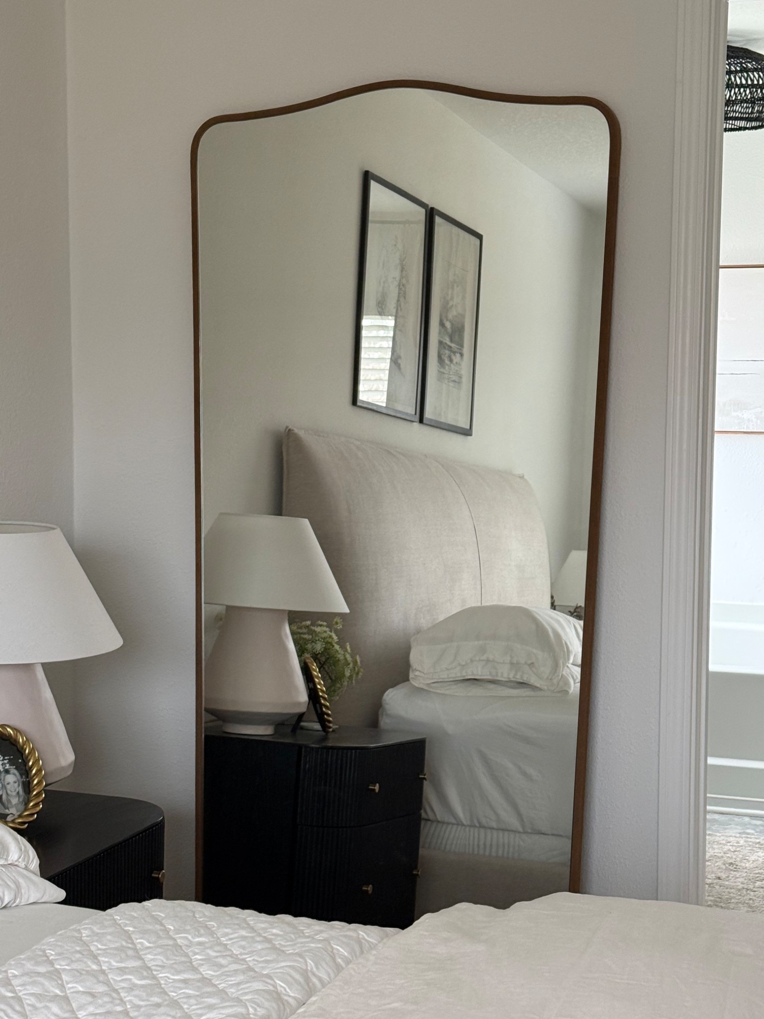 Always love a good reflection!  This is my all time favorite floor mirror ever!  And the frame is suede!!  The curved top and shape are 👌🏻 

Master bedroom, primary bedroom l, bedding, bedroom decor, home decor, white lamp, cream lamp, black nightstands 
