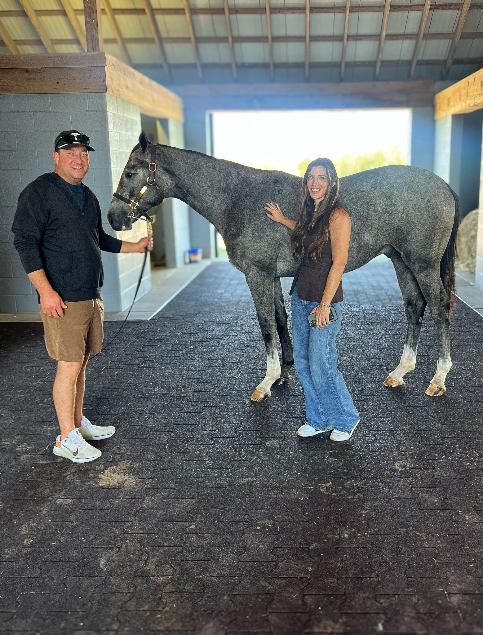 Feeling beyond thankful for the incredible team we’ve met and partnered with in this horse racing world — people who genuinely love these horses and take such amazing care of them. Owning horses has been my dream since I was a little girl, and it still feels surreal that it’s finally come true. Watching our two-year-olds grow before they ever hit the track is such a special experience.  There’s a heated debate over what to name this handsome grey colt, so drop your suggestions below! Filly name reveal coming soon! 

#HorseRacing #ThoroughbredLife #EquestrianLifestyle #RacehorseOwner #HorseRacingDreams #FarmLife #CountryLifestyle #EquestrianGoals #HorseLovers #StableLife #DreamComeTrue #RaisingRacehorses #FutureChampion #EquestrianCommunity #LikeToKnowItLifestyle #LTKEquestrian #LTKCountryLife #LTKFarmStyle

⸻

Outfits:
Casual and comfortable barn day looks! He’s wearing a black quarter zip hoodie, khaki shorts, Nike sneakers, and a baseball cap — classic, sporty, and functional for a day at the farm. I’m wearing a chocolate brown sleeveless top, high-rise flared jeans, and white sneakers — easy, effortless style that’s both flattering and practical for walking the barn aisles.

#EquestrianStyle #CountryOutfit #BarnStyle #CasualChic #LTKStyle #LTKUnder100 #FarmFashion #RanchWear #HisAndHersStyle #WeekendStyle

#LTKOver40 #LTKMens #LTKTravel