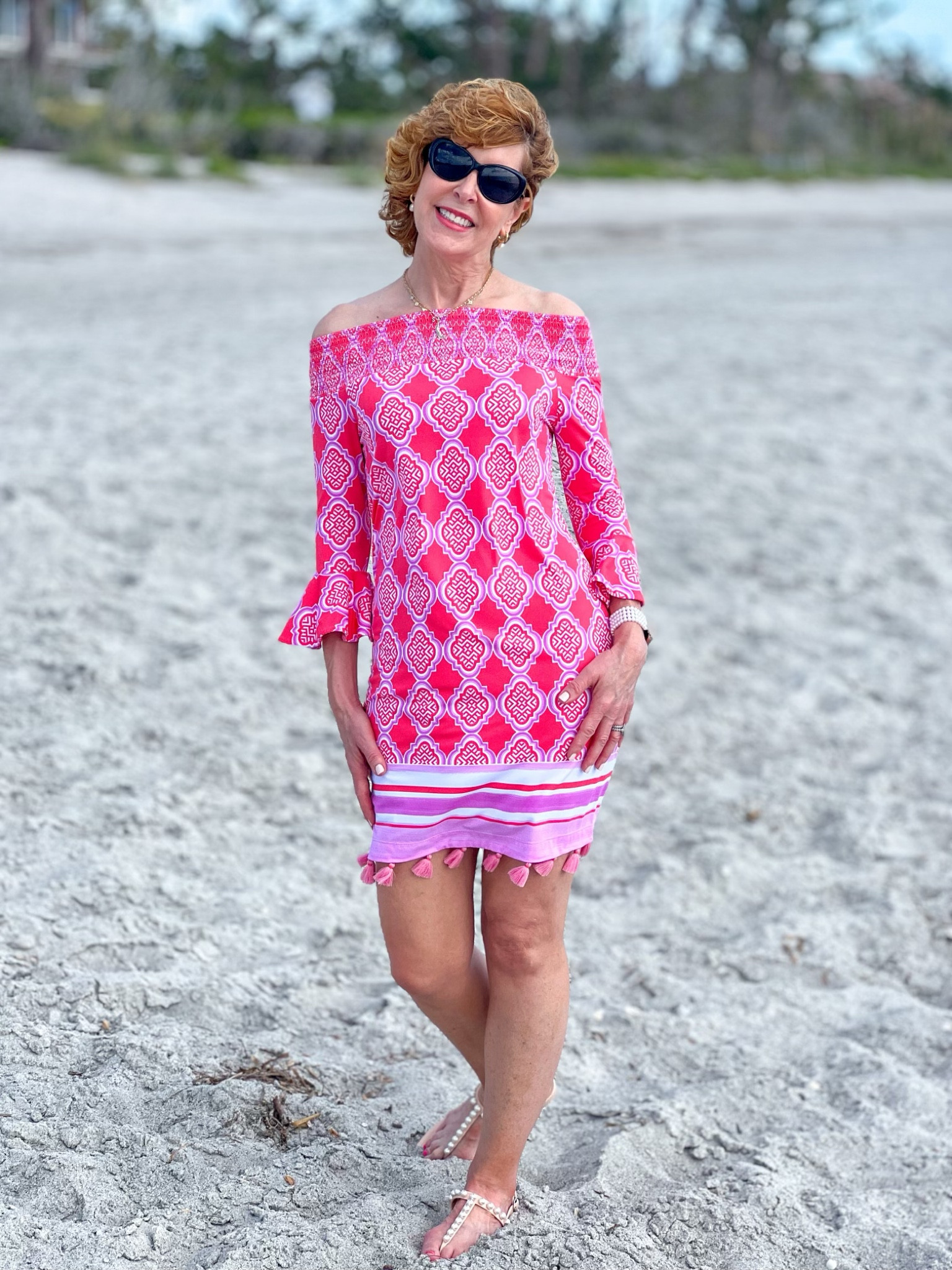 I love the feminine detailing on this darling off-the-shoulder dress. It has pretty ruffled bell sleeves, a smocked neckline, and the cutest tassel hem. Best of all, it's UPF 50+, which is huge for someone as sun-sensitive as I am.          
I paired it with the most darling pair of pearl embellished sandals, a pearl Apple Watch band, and pearl & gold hoop earrings.


#LTKSeasonal #LTKstyletip