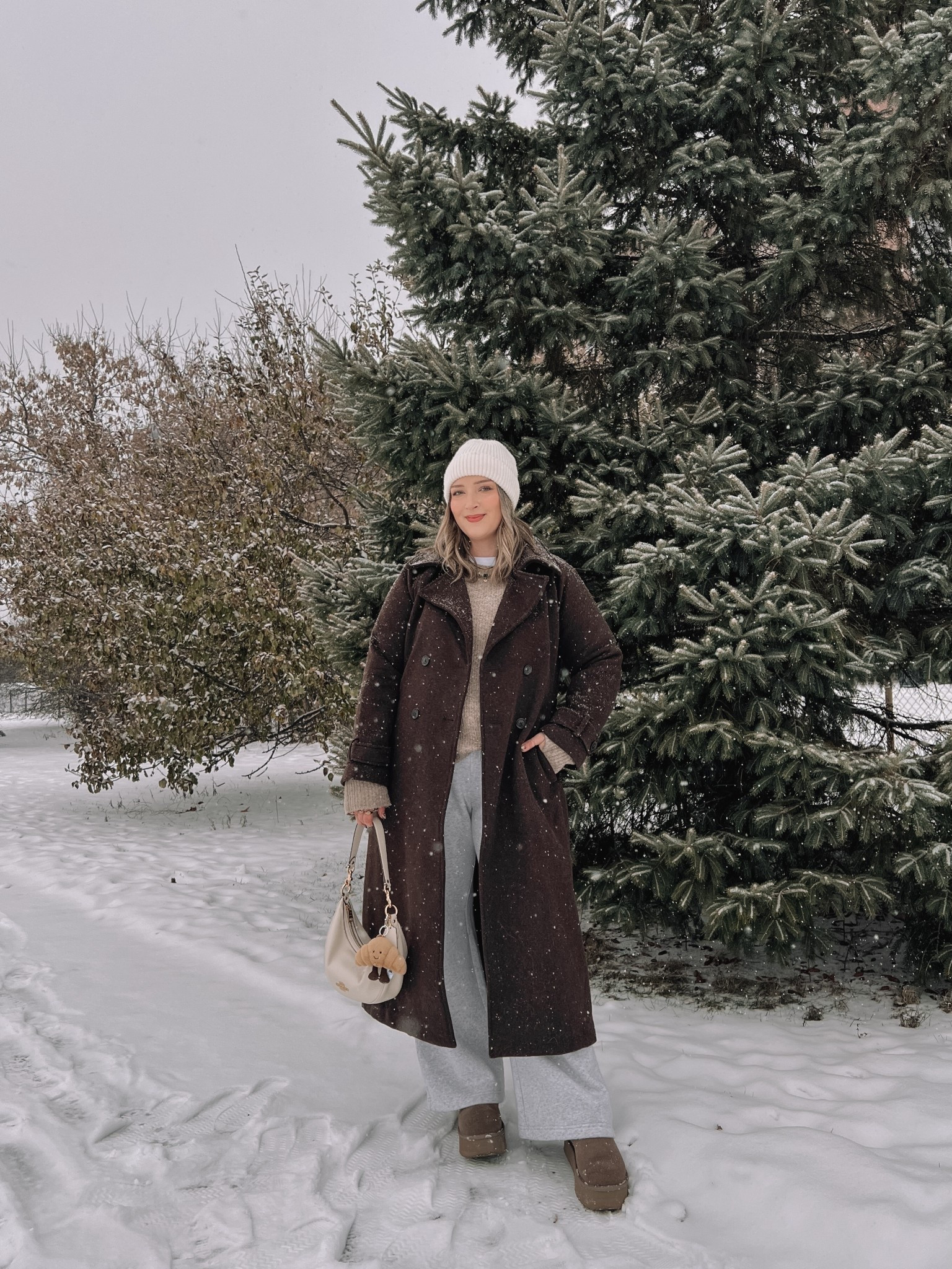 Cozy winter outfit! Wearing my usual size L in the chocolate brown wool trench coat - it’s so warm and such a good staple piece! Also wearing L in the wide leg sweatpants, these are thick and cozy and cute enough to wear out! This white tee is my fave for layering since the neck is higher, wearing my usual size L. My Ugg style boots are Amazon and such good quality! I’m usually a 9.5-10 and wear a 10 in these. Linked similar neutral sweaters & cream beanie


#LTKmidsize #LTKstyletip #LTKwinter