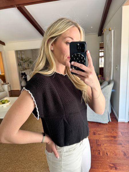 Cutest black sweater top with scalloped detail. Throw on with white high waisted jeans and sneakers for everyday outfit idea. Amazon top is very cropped. I sized up to a medium. I’m 5’6 for reference and have a shorter torso and long legs. #amazonfashion 

#LTKfindsunder50 #LTKstyletip #LTKSeasonal