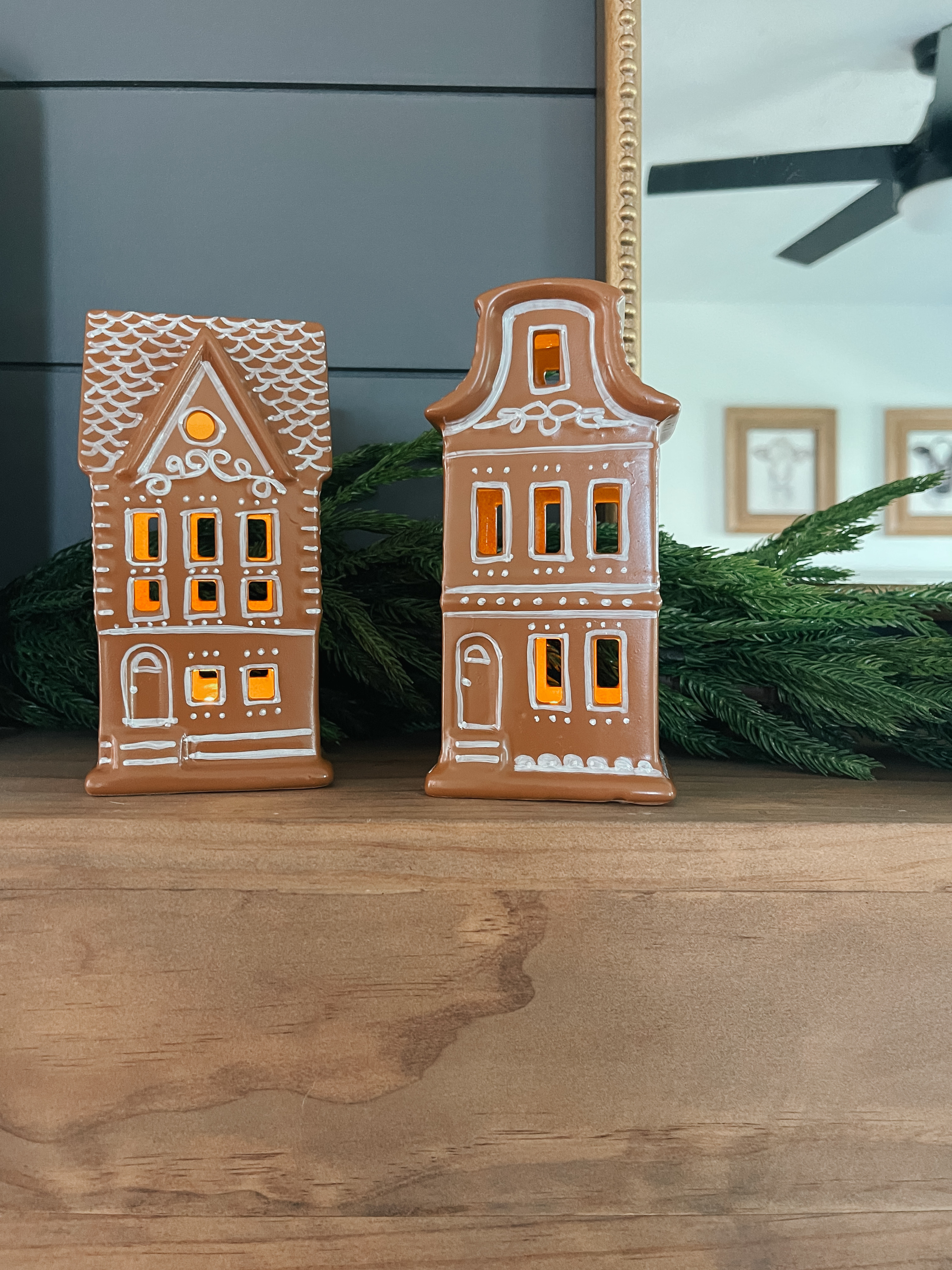Turn plain ceramic light-up houses into DIY gingerbread houses with spray paint and a white paint pen! This easy holiday craft is budget-friendly, high-end looking, and perfect for Christmas decor, mantel styling, or a festive gingerbread village. #Christmasdecor 

 #LTKSeasonal #LTKHome #LTKFindsUnder50