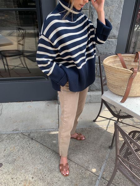 Gap striped sweater. Mine is from last year but linked the exact one from Gap Factory. Jeans are old Gap, linked similar. Fall outfit ideas. Transitional dressing 

Gap sweater petite xs
Gap jeans petite 25
Hermes Oran sandals 35
Loewe tote Medium 

#LTKSeasonal #LTKunder50 #LTKunder100