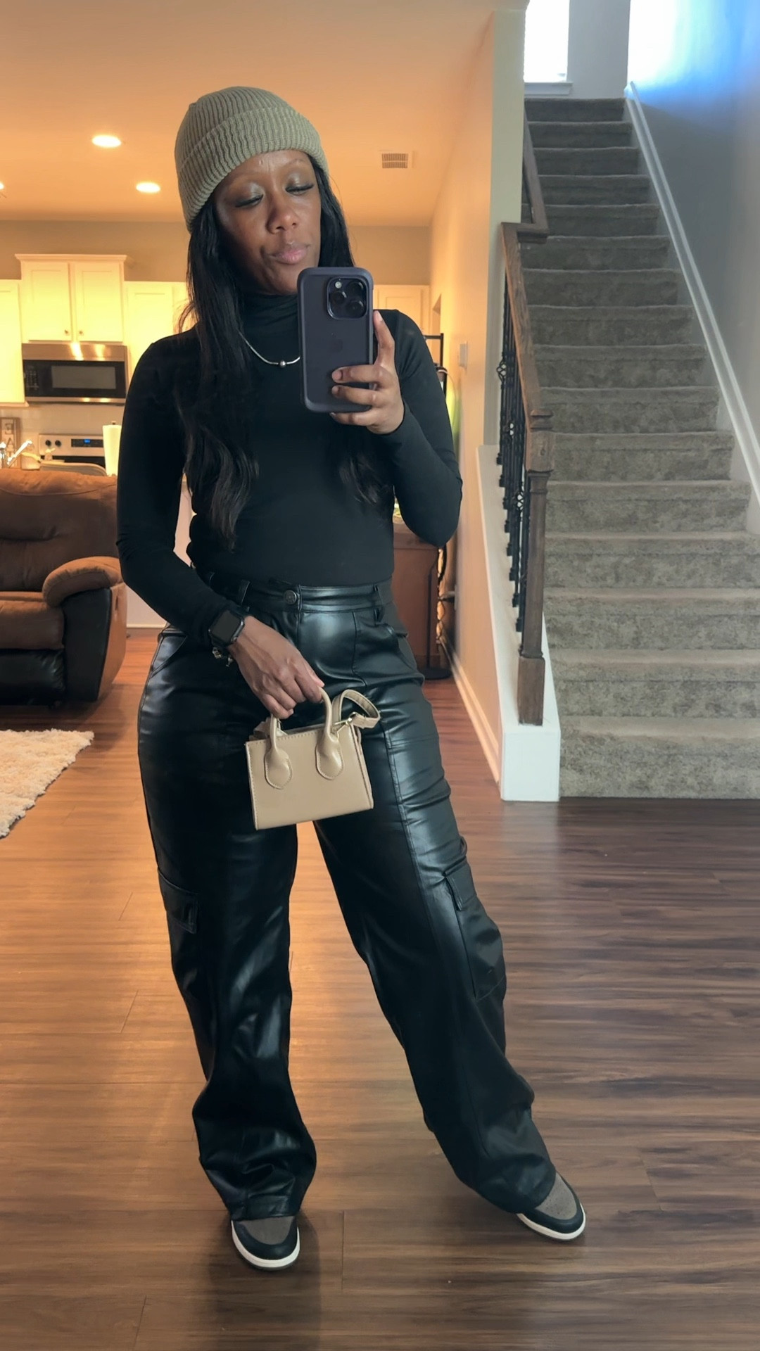 A simple way to wear all black with taupe. Black bodysuit, black wide leg cargo pants, taupe beanie, taupe purse, Jordan 1 palomino sneakers 

#LTKSeasonal #LTKStyleTip #LTKShoeCrush