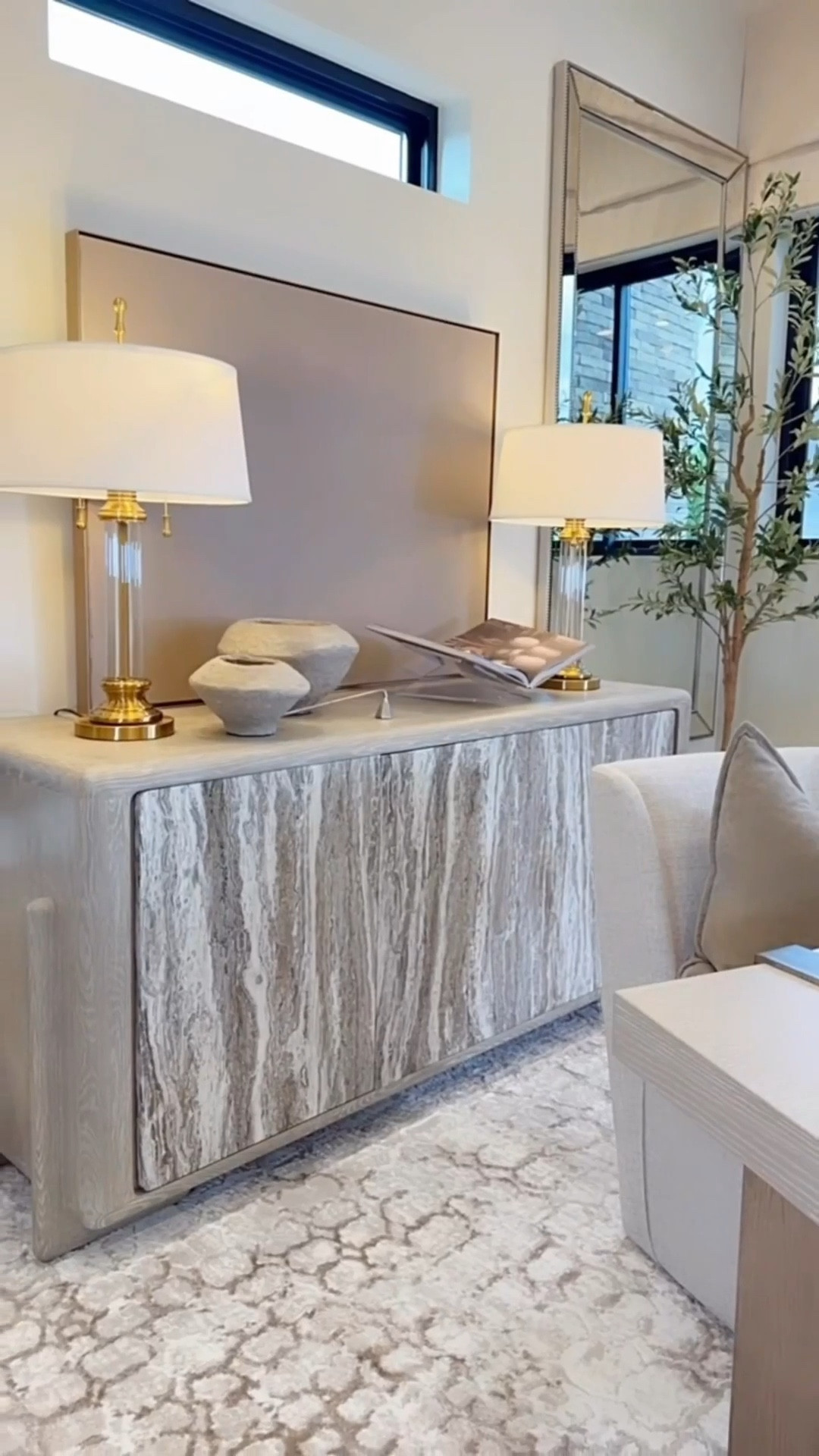 It was so fun making over this space 🤍 I absolutely love how it turned out. The rug has the perfect creams, browns and grey/silvers, the mirrors make the room feel larger and I love the bedded details, and the olive trees were such an affordable way to bring in the perfect touch of green. The lamps are even prettier in person, the desk is simply beautiful, and the light fixture is one of my favorite pieces. I’ve also been loving motorized Roman shades lately!! They add such a soft, elevated feel to the whole space. 🤍 

amazon home decor
neutral home decor
designer inspired office 
office makeover decor on a budget

Summerthompsonstyles 

#LTKHome #LTKU #LTKSaleAlert