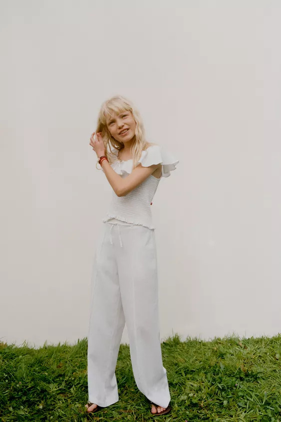 Trousers with an elasticated back waistband and adjustable drawstring at the waist. Featuring pat... | Zara UK