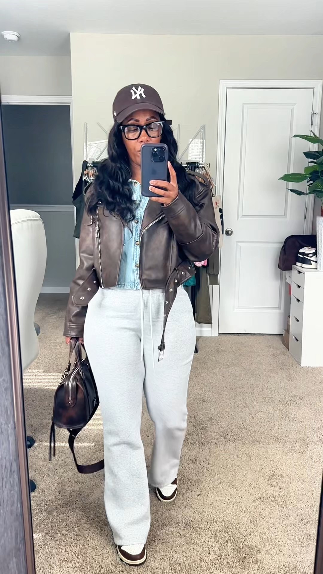 Outfit of the day 🤎 brown faux leather jacket, cropped denim shirt, grey sweatpants styled with a brown baseball hat, brown purse, and Nike dunk low cacao wow sneakers

#LTKPetite #LTKootd #LTKFindsUnder50