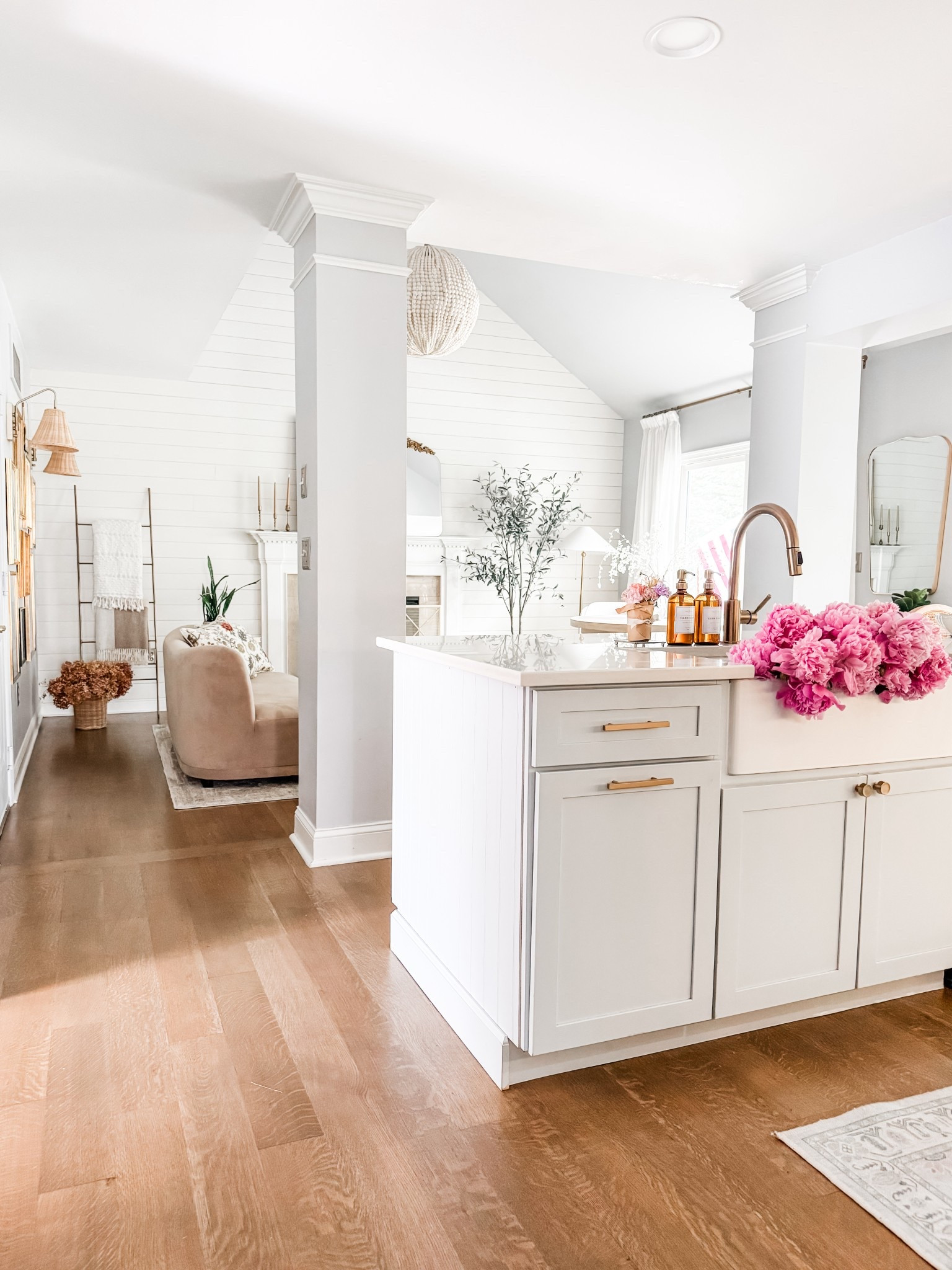 Summer kitchen view

Kitchen runner
Glass soap dispenser
Pretty soap dispenser
Warm gold faucet
Champagne bronze drawer pull
Cabinetry hardware
Farmhouse sink
Wood bead chandelier 
Pottery barn chandelier
West elm sofa 
Velvet curved loveseat 
Wicker wall sconce
Rattan wall sconce
Artificial olive tree Studio McGee olive tree
Living room decor
Kitchen decor
Amazon pinch pleat curtains
Mella sofa west elm 


#LTKHome #LTKStyleTip #LTKFindsUnder50