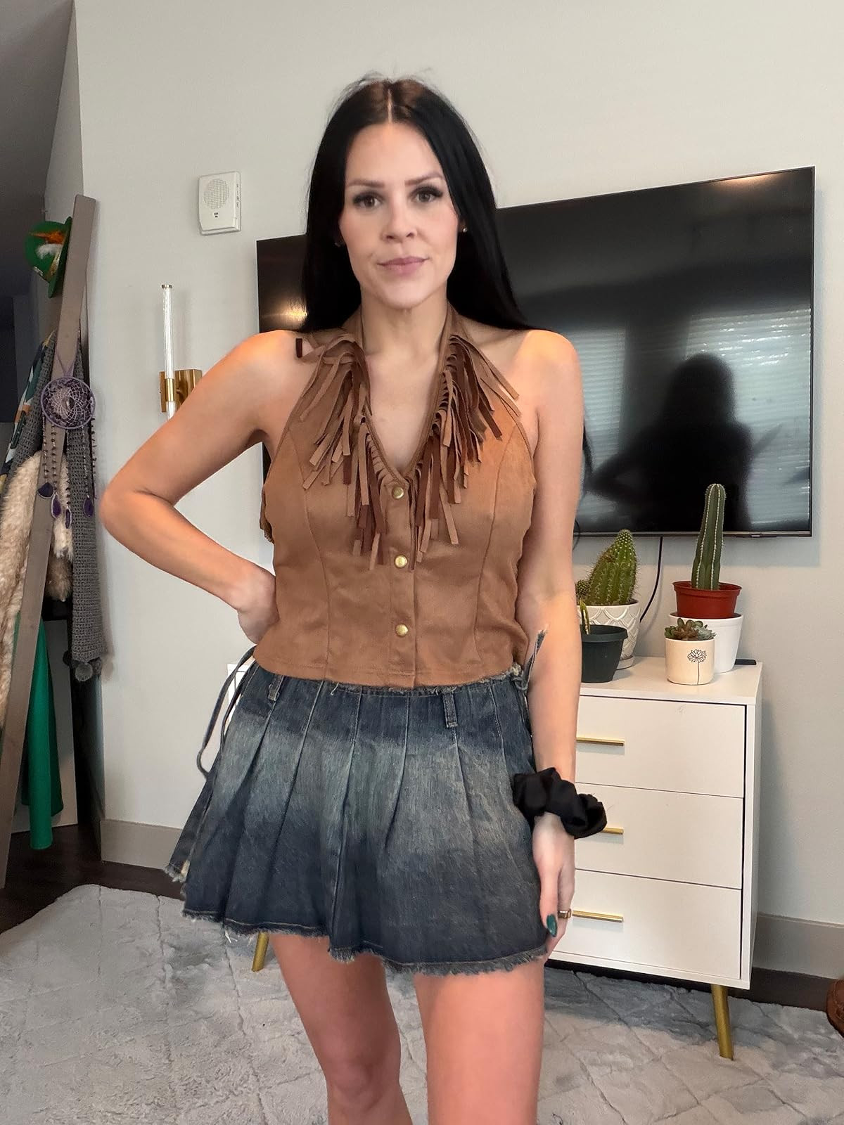 Western flair. This festival-ready look features a tan suede-style halter top with fringe and button details, paired with a pleated dark wash denim mini skirt and a black scrunchie. #WesternStyle #FestivalOutfit #LTKunder50 

 #LTKdayinmylife #LTKgrwm #LTKootd