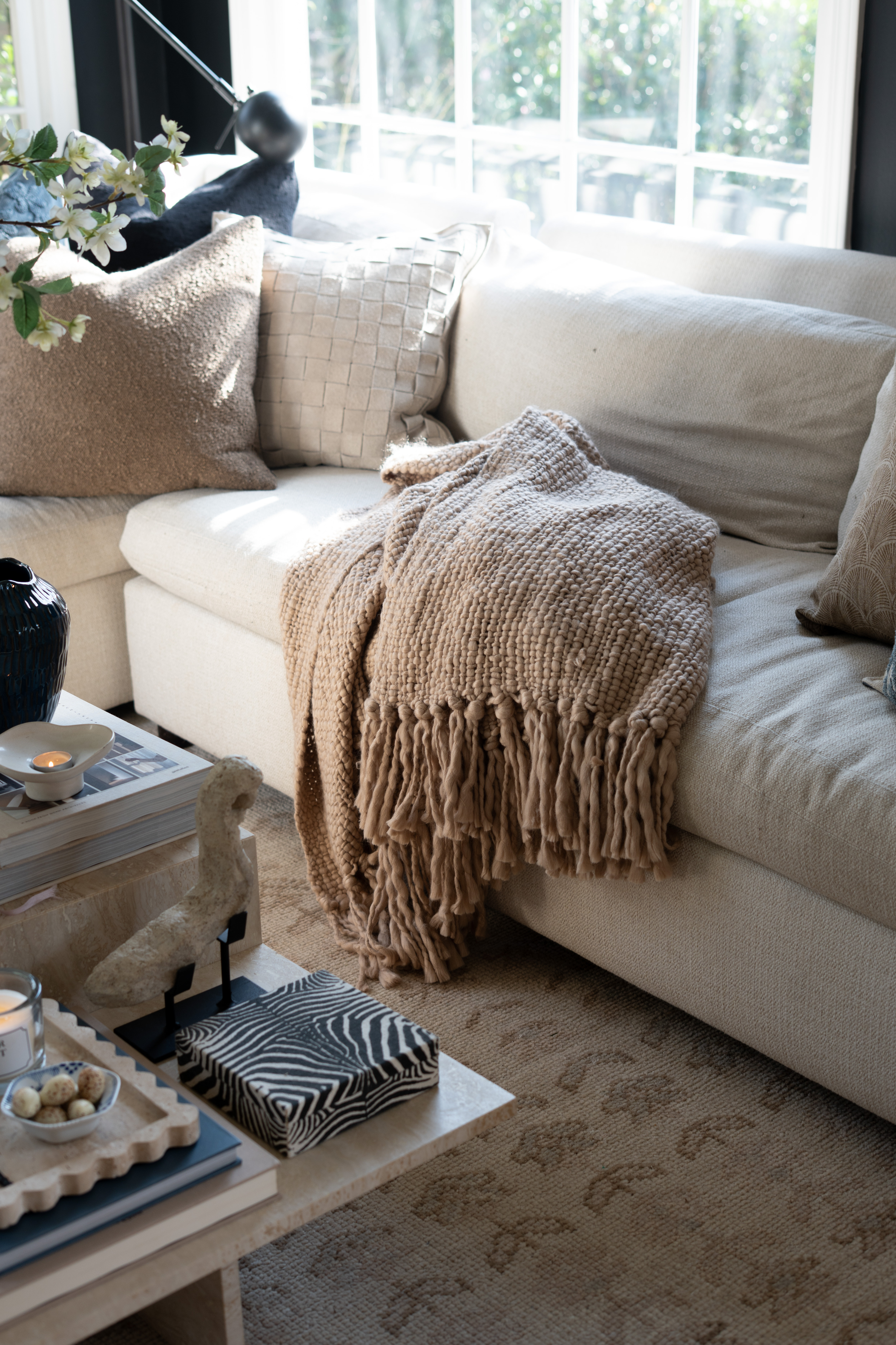 This little living room moment is giving all the cozy vibes. The spring florals, textured pillows, chunky knit throw, and marble coffee table styling make this space feel warm, relaxed, and effortlessly styled. EEEP I am so here for it all!!  

 #LTKSpringSale #LTKSeasonal #LTKHome