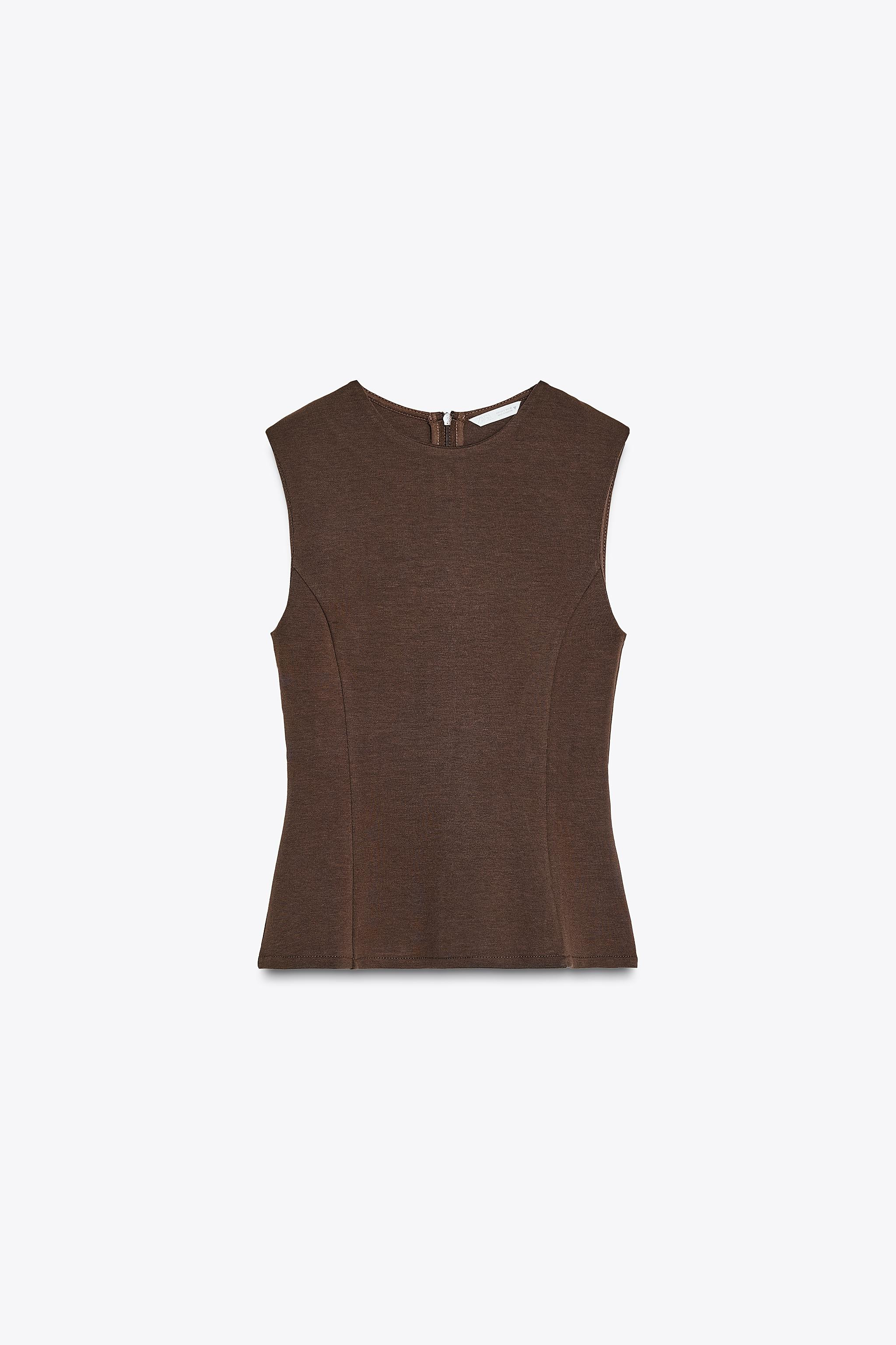 Top made of soft, opaque and compact stretch knit fabric. Round neck and sleeveless. Peplum hem. ... | Zara UK