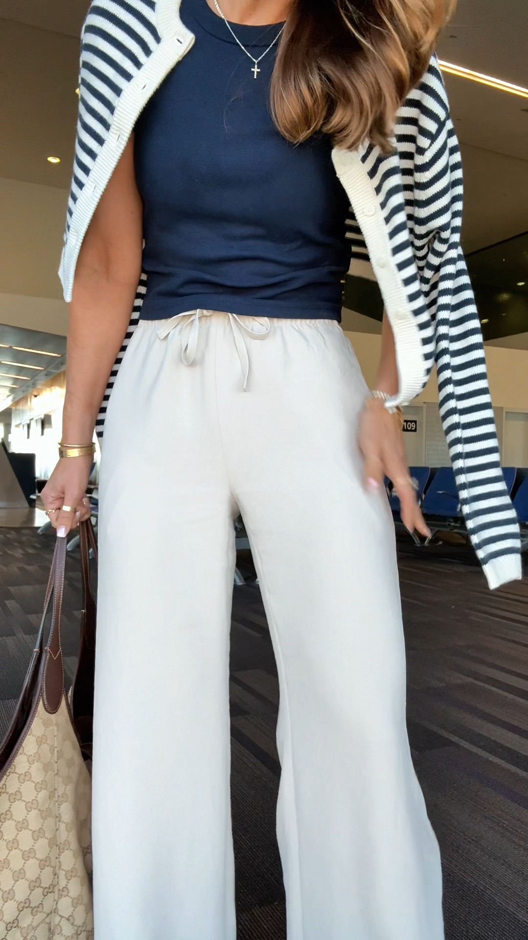 My travel outfit of the day! Aritzia The Lodge Pant - Crepette. Size XS regular, but I prefer short (I ended up comparing the 2). Comes in short and tall, too. Wrinkle resistant with an elastic waist and high-rise. Aritzia t-shirt in XS. Aritzia striped cropped cardigan in 2XS. Jelly ballet flats are whole sizes only. I’m a 6.5 and sized down to a 6 per reviews. Business casual. Elevated casual. Workwear. Coastal outfit.