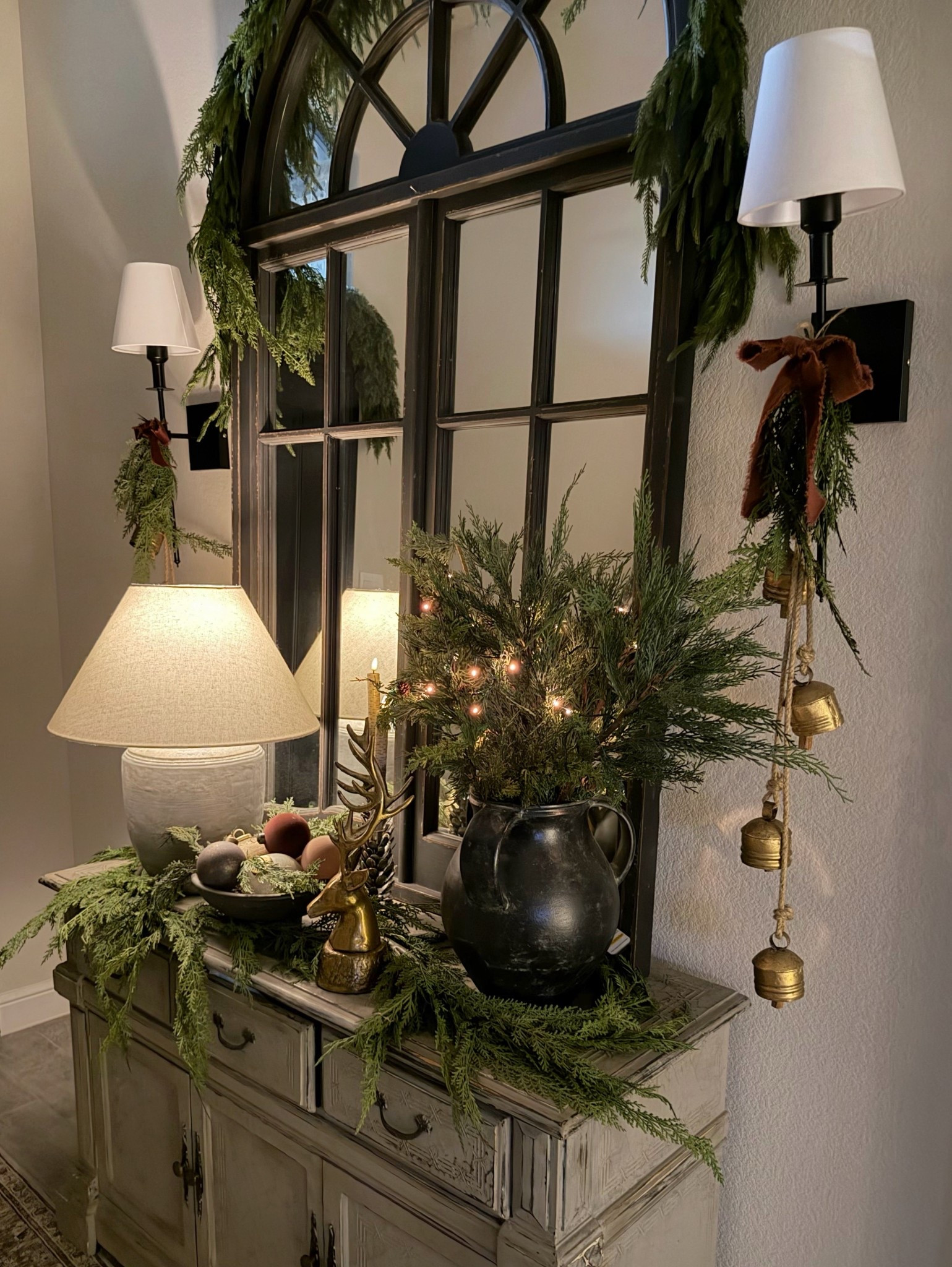 Set the tone for a warm and cozy Christmas with a beautiful entry way to welcome your guests. It’s as simple as greenery, ornaments, bells and the glow of candles. 

#LTKHome #LTKHoliday #LTKSeasonal