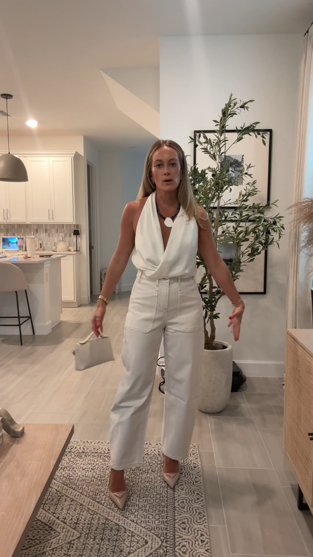 Girls night out dinner fit wearing a satin halter draped top with Spanx white barrel denim, Prada heels and Amazon bag