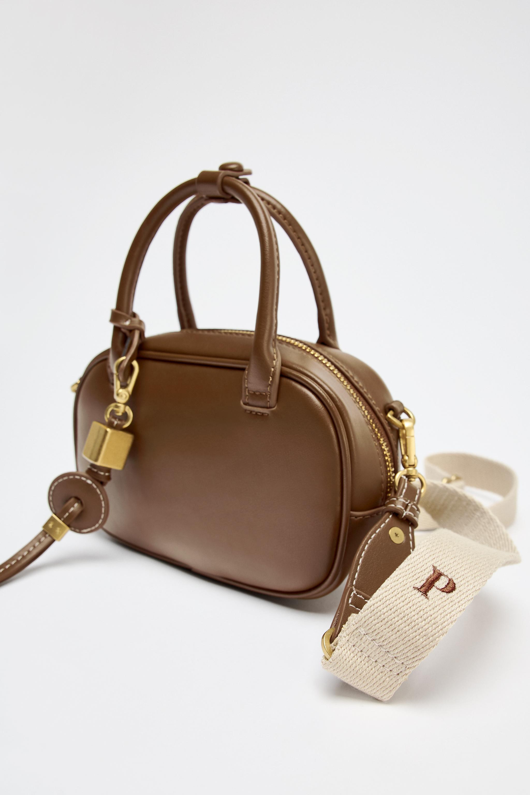 Mini bag. Charm detail with metal pieces. Top handle and double removable crossbody strap, one in... | Zara US
