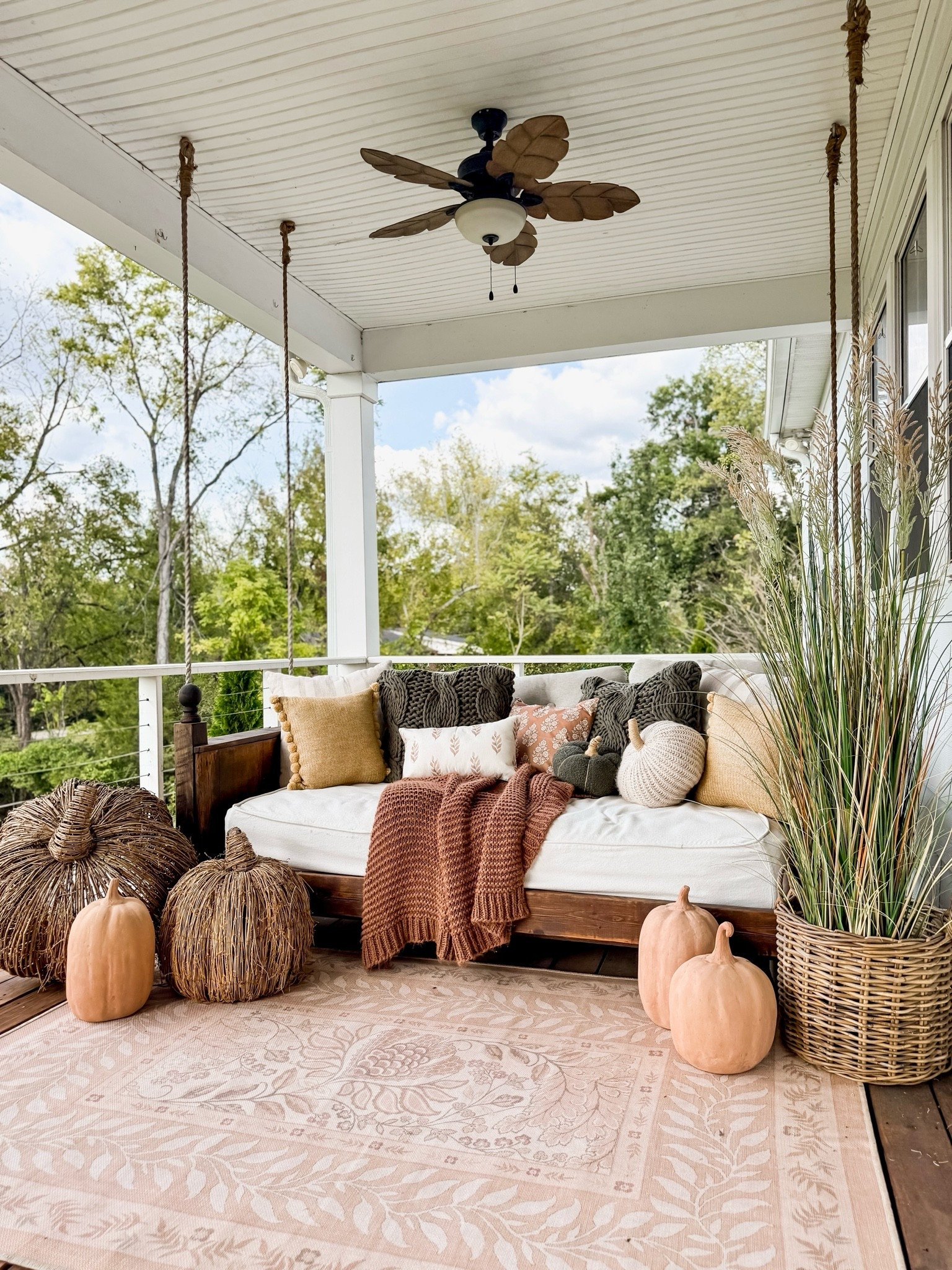 fall porch decorating idea for 2026! This was my front porch bed swing decoratedd tor the fall season a few years back. The mix of textures with the grass, pumpkins and pillows was so cozy!

#LTKSaleAlert #LTKHome #LTKSeasonal