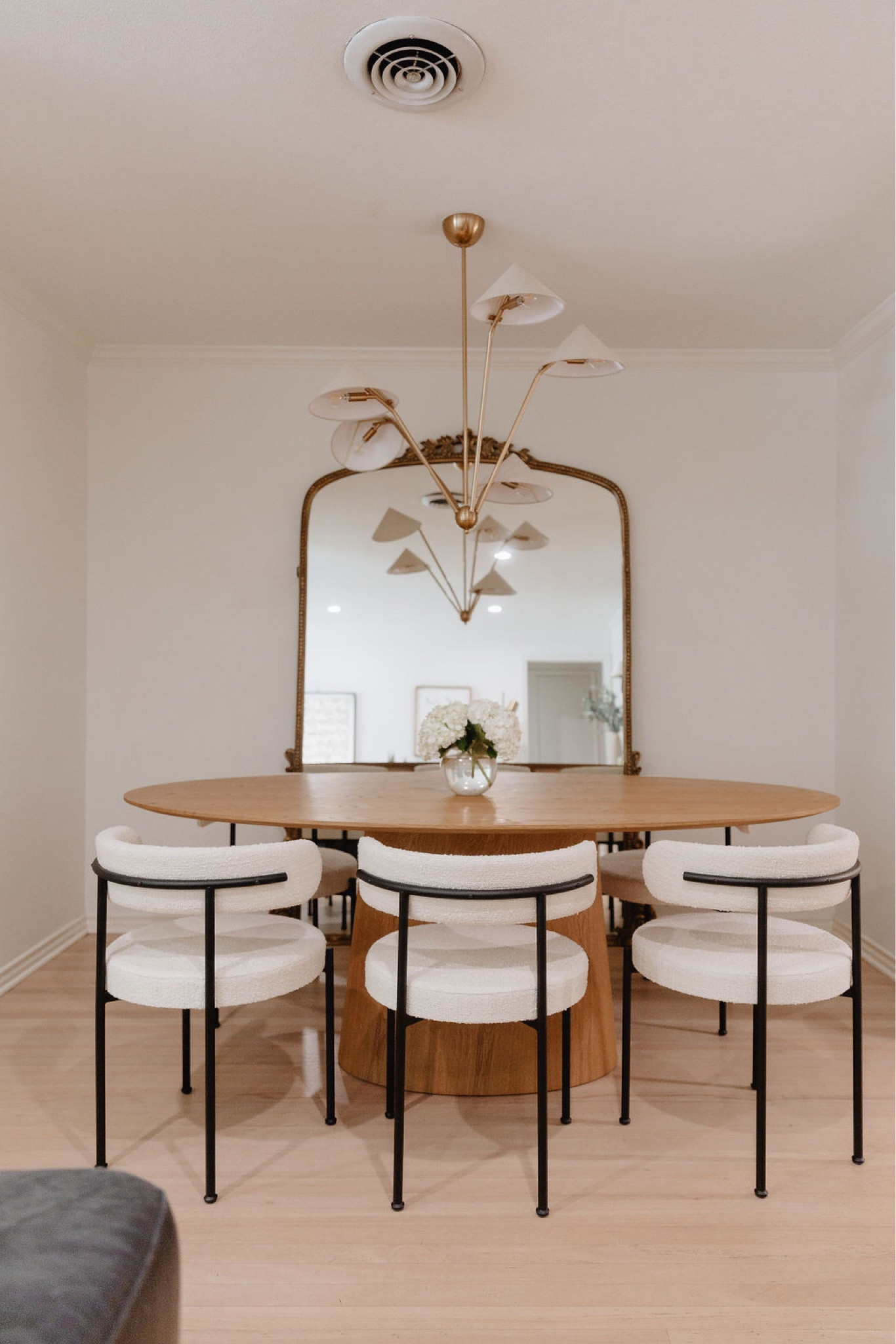 Dining room // home decor, dining room decor, dining room chairs, dining room table, candle holder, pampas grass, candleholders, dining table, chandelier, mirror, CB2, dried eucalyptus, vase, faux sheepskin, candles, table runner, Amazon home decor, modern home decor, modern decor, tablescape, modern home decor, neutral home decor, dining room, dining room decor, living room, living room decor