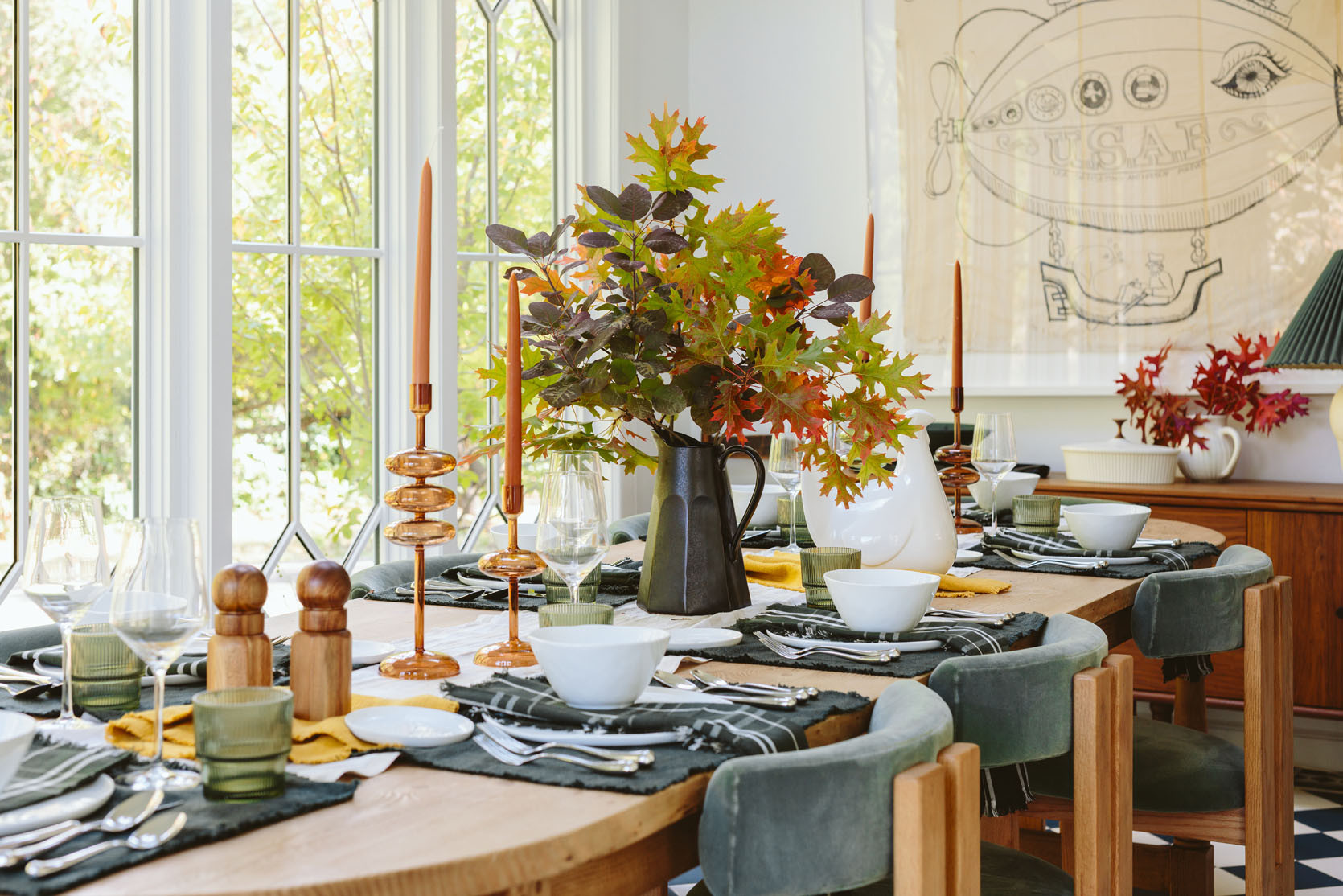 As you can see, we have some fall motifs – the plaid runner, the amber candle holders (and candlesticks), one mustard napkin, some fall leaves and you know, THE HUGE CERAMIC TURKEY. But beyond that, it’s just white plates, with green napkins, glassware, and pretty silver flatware. All these things work year-round in my house (which leans green/blue modern farmhouse).

I think it’s fun to think of some of these colors, patterns, and elements as “seasonal indicators”. Fall branches + mustard + a warm plaid + Turkey = Thanksgiving. Some scattered pine cones or wicker/wood elements for turkey day and you get the same “vibe”.

#LTKParties #LTKSeasonal #LTKHome