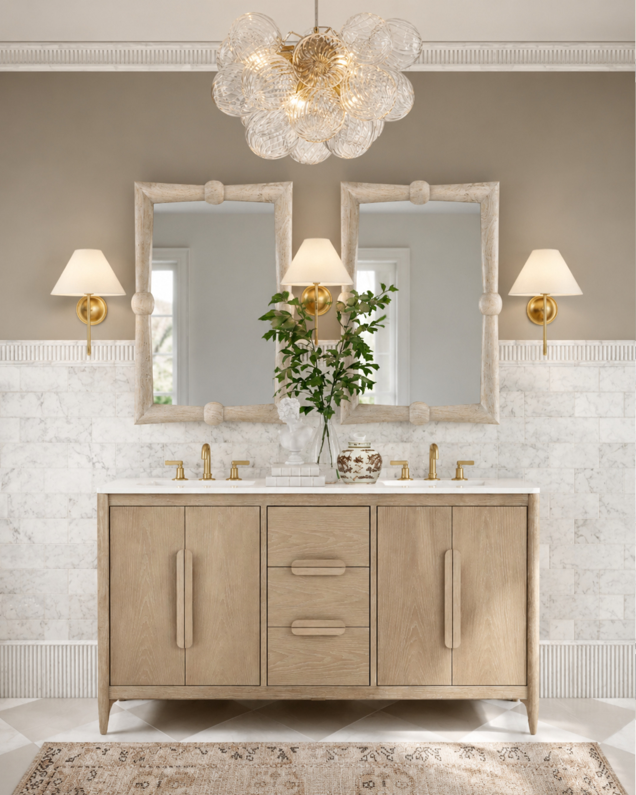 This bathroom is exactly why I’ll never get tired of warm neutrals and layered textures. ✨

The soft oak vanity, marble walls, aged brass accents, and sculptural lighting make the entire space feel calm, elevated, and timeless. I especially love the mix of organic materials with polished finishes — it keeps the room feeling luxurious without feeling overly formal.

Saving every detail here, from the statement chandelier to the oversized mirrors and warm wood cabinetry. This is the kind of bathroom that instantly makes a home feel expensive. 

 #LTKHome