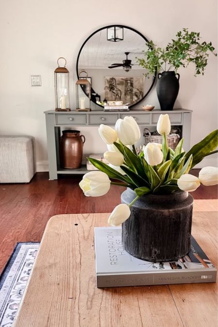 Affordable spring home decor! 
The tulips from Amazon are so realistic! 
Spring console table decor, coffee table books, lanterns 

#LTKunder50 #LTKhome #LTKstyletip