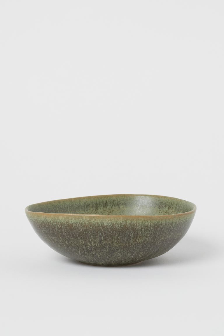 Asymmetric-shaped bowl in glazed stoneware. Height approx. 2 in., diameter at top approx. 6 in. | H&M (US + CA)