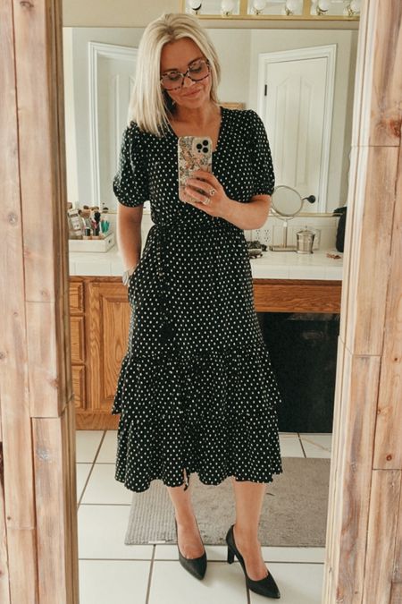 This dress is full wrap dress with glorious pockets and puff sleeves. The sleeves are a little longer which I love. The tassel tie is a darling detail as well. I love this dress so much I have it in the stripe as well. 
I’m wearing a size small and I’m 5’6”.
I looked for years for the best black pump and these are definitely the ones. You won’t regret investing in a good pair of black pumps.
Add these leather earrings and fun oversize readers for the complete look!

#LTKbeauty #LTKunder50 #LTKshoecrush