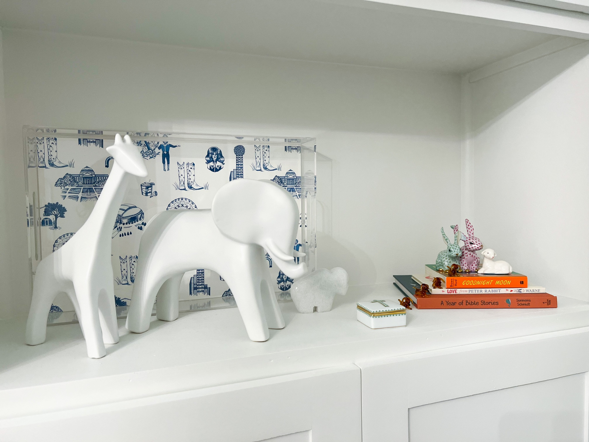 Nursery bookshelf decor! Love our white glass animals, they are a perfect size too! 

The Dallas acrylic tray is on SALE! She has tons of fun prints! 


#LTKsalealert #LTKbaby #LTKfamily