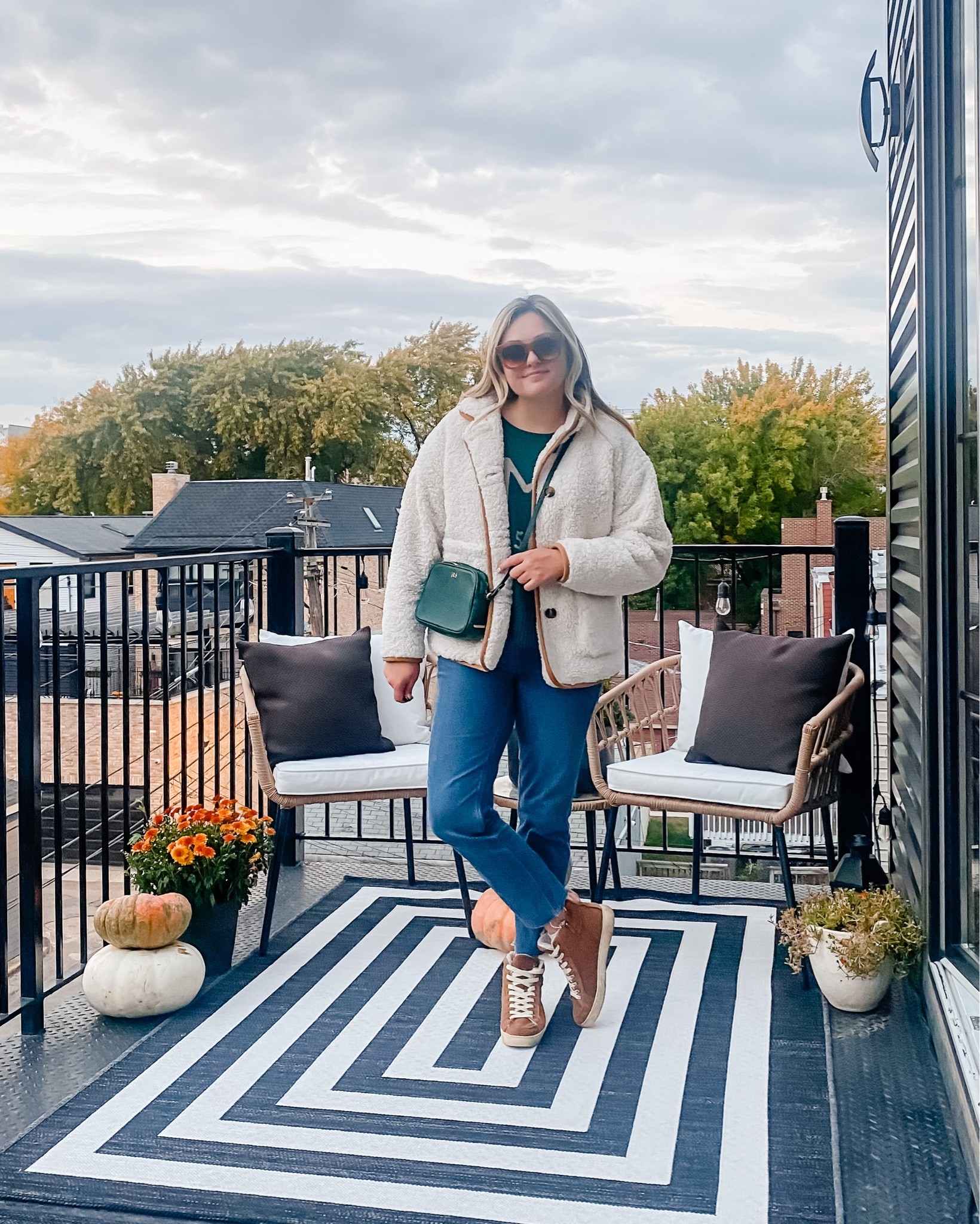 Sherpa Teddy Coat. Monogrammed Crossbody. Straight leg jeans. Suede sneakers. 