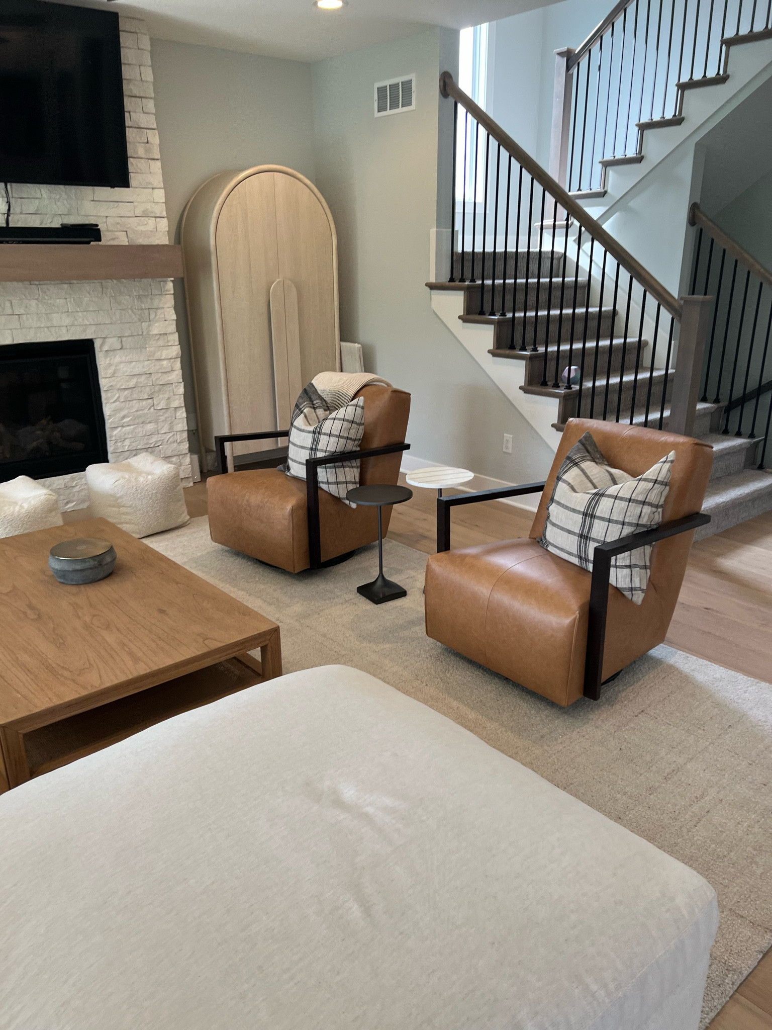Cozy seating area in neutral living room with organic modern feel, leather glider chairs, and a blonde / bleached wood ford cabinet 


#LTKhome #LTKCyberWeek
