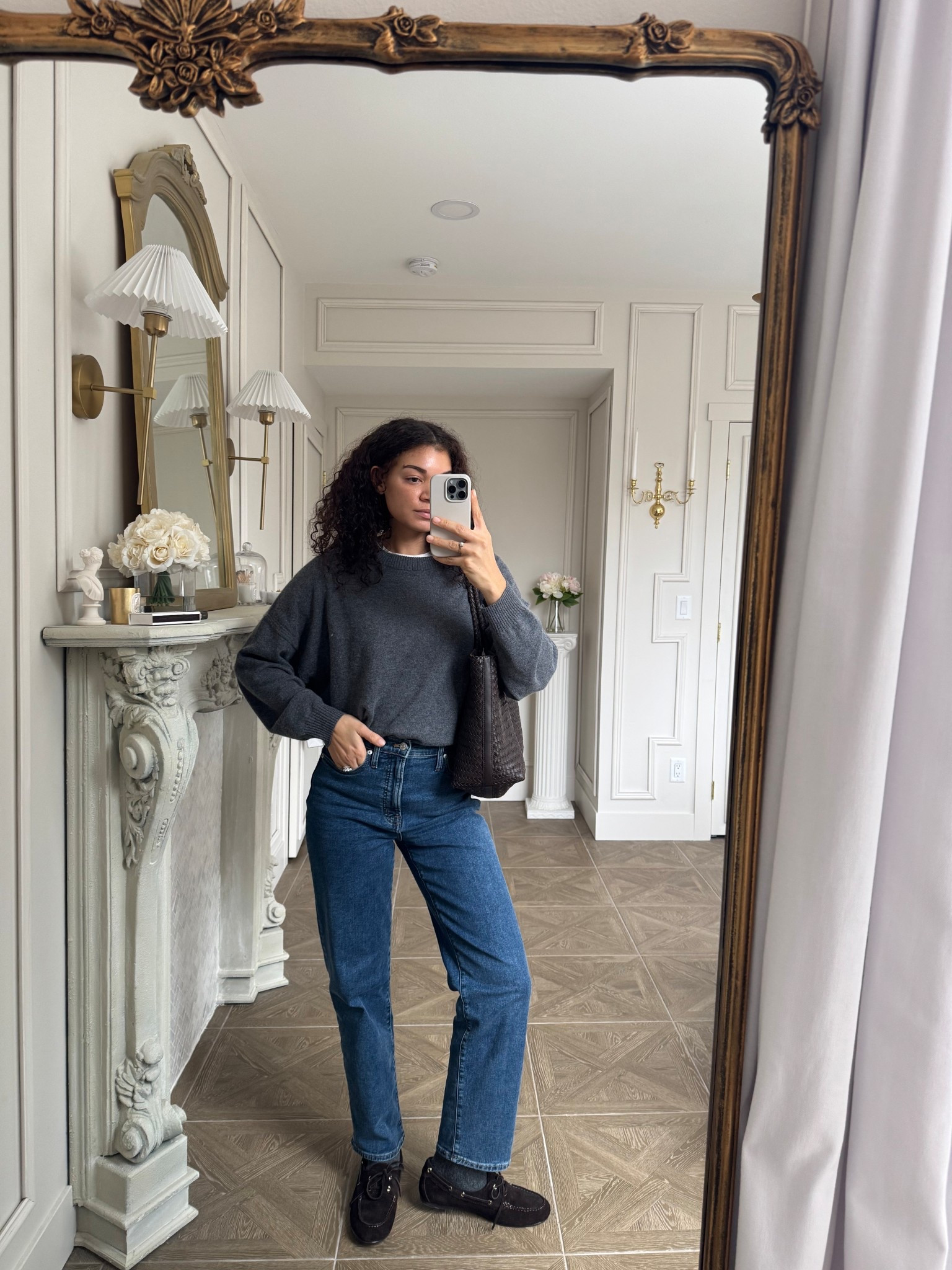 Casual outfit: cashmere sweater layered over a white t-shirt, jeans, tote bag, boat shoes, and socks 

#LTKootd