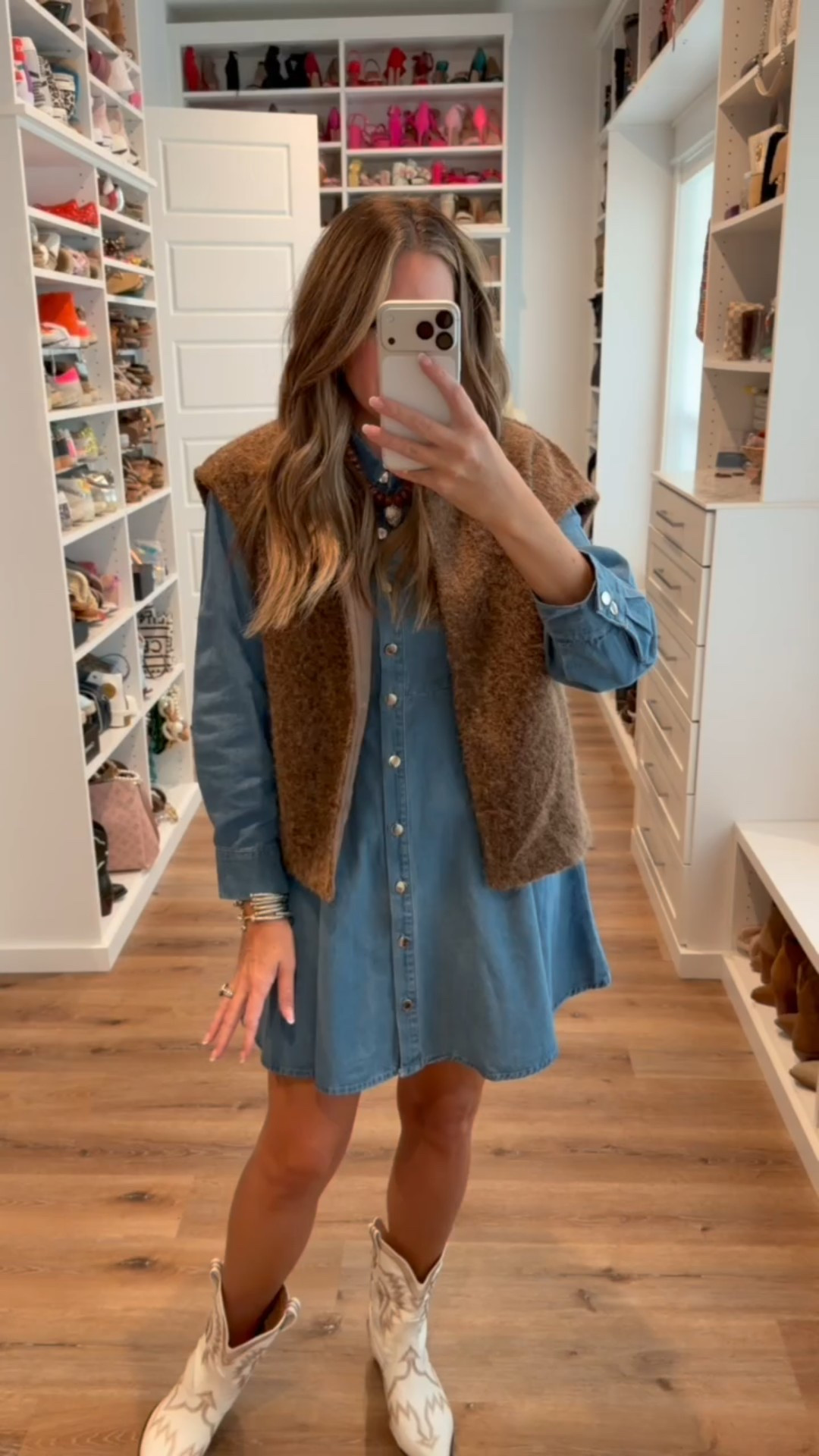 In a medium vest, small denim button down long sleeve ruffle bottom dress, necklace, boots and accessories- fits tts.

#LTKStyleTip #LTKFindsUnder50 #LTKSeasonal