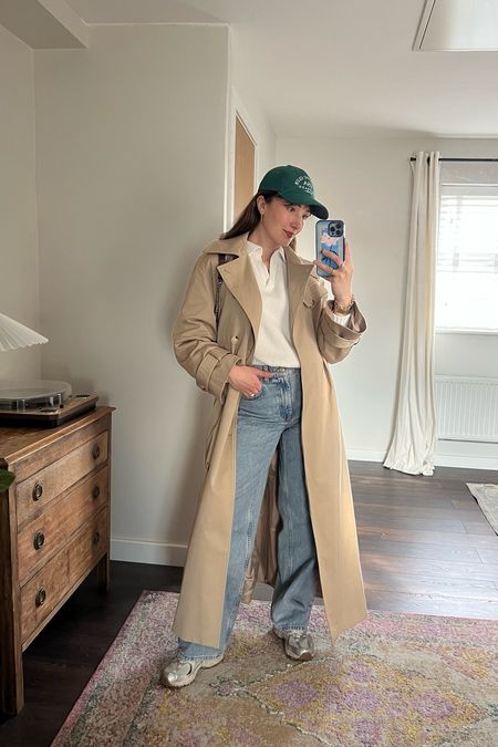 Long trench coat, wide leg jeans and cap